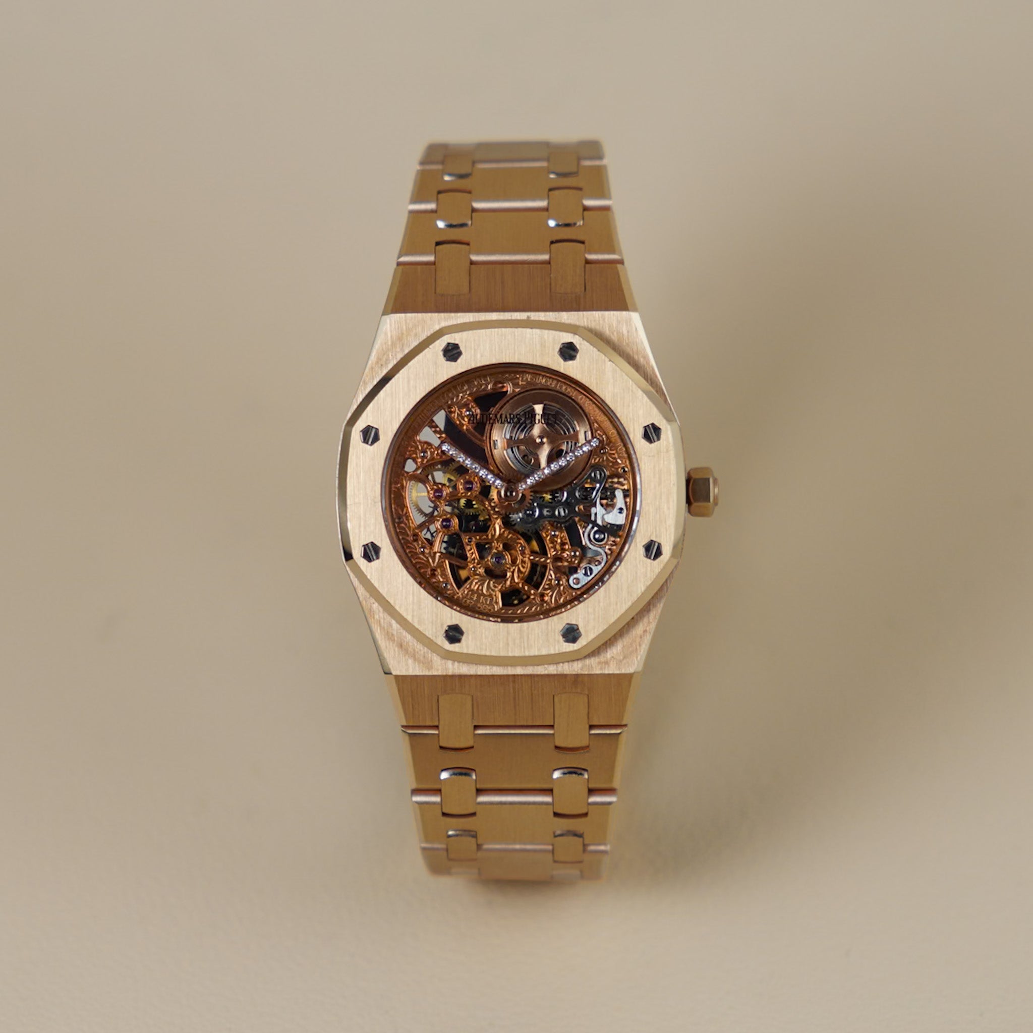 A luxury wristwatch with a light natural wood octagonal case and a matching wood-and-metal link bracelet, featuring a skeletonized dial with a visible mechanical movement.