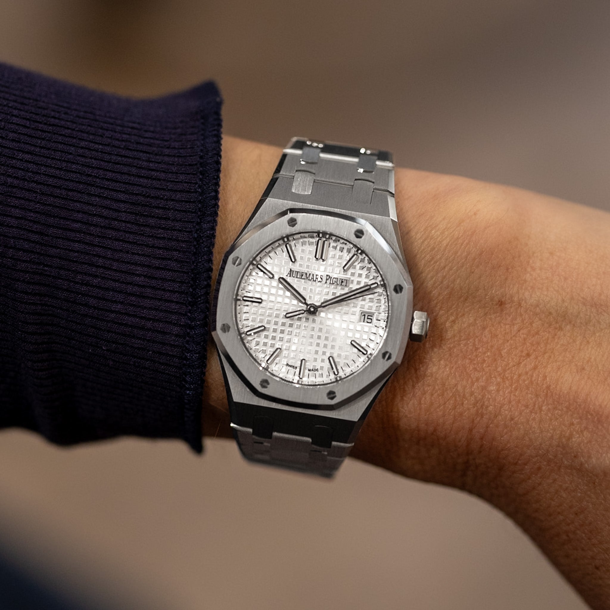 Audemars Piguet Royal Oak 34 mm stainless steel watch with silver “Grande Tapisserie” dial, white-gold applied baton hour markers, date at 3 o’clock, integrated steel bracelet.