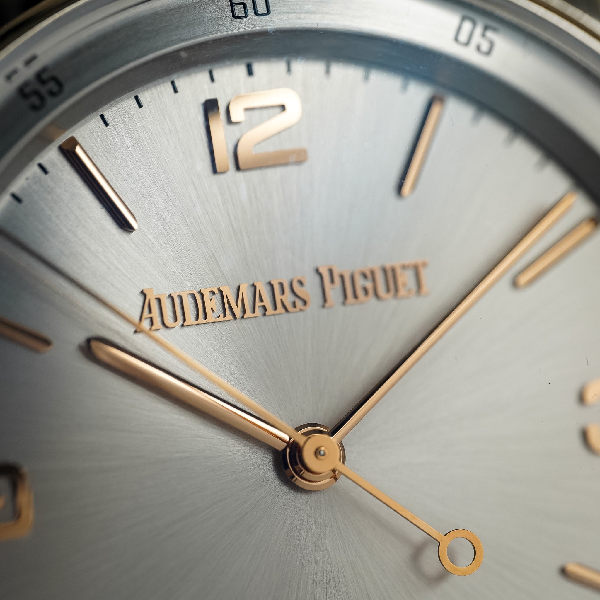 Close-up of an Audemars Piguet watch face with gold hands and details.