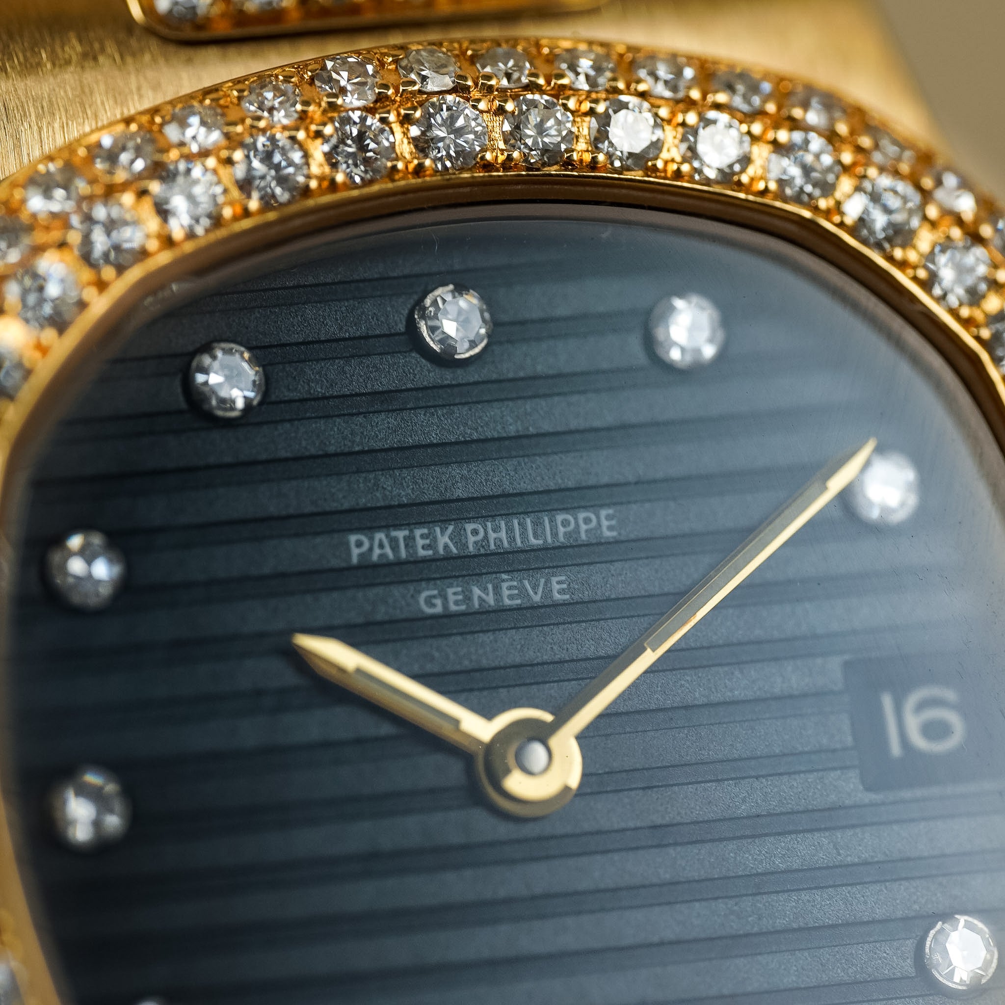 Close-up of a Patek Philippe watch with diamond-studded bezel