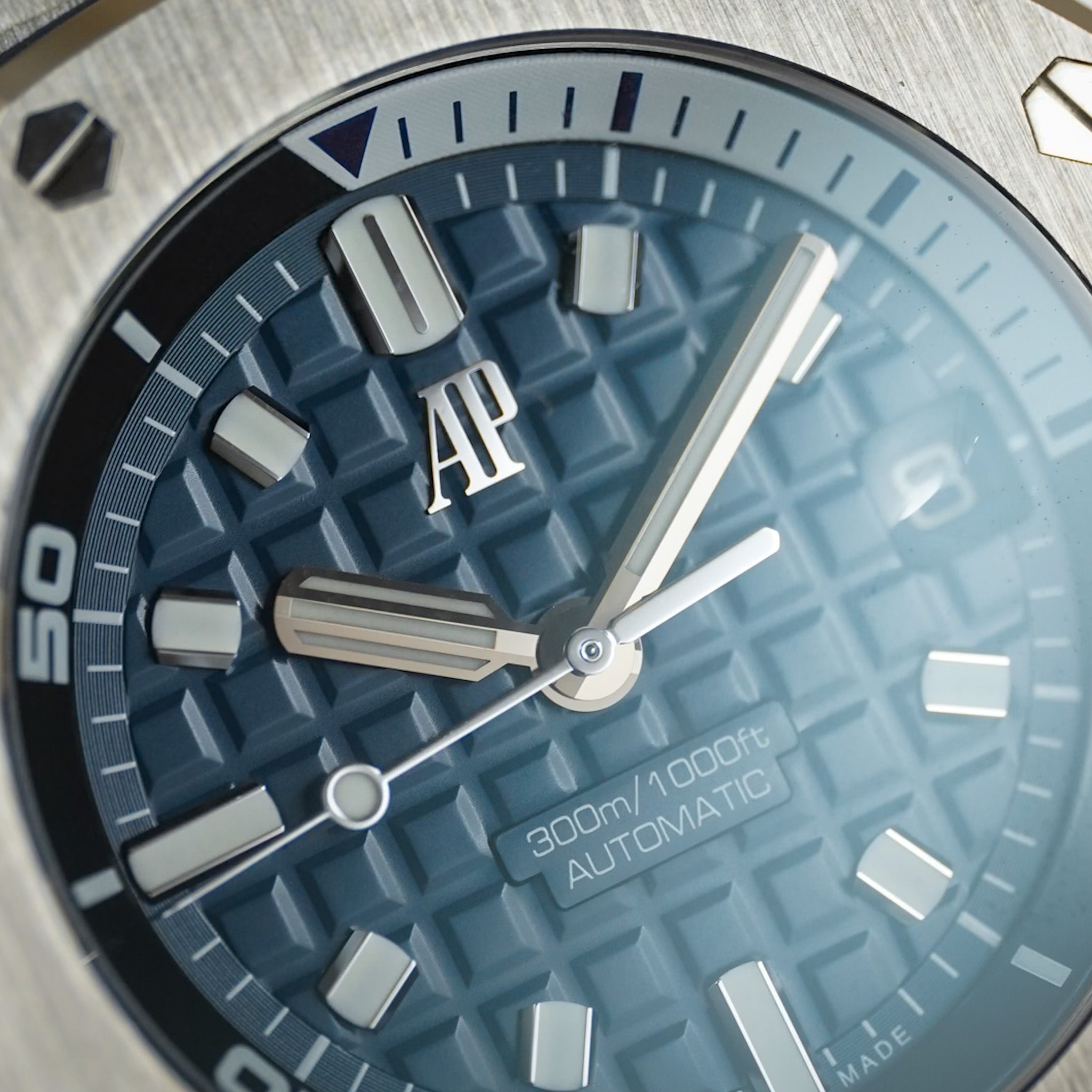 Close-up of an Audemars Piguet Royal Oak Offshore Diver texuted dial in navy blue with a steel case