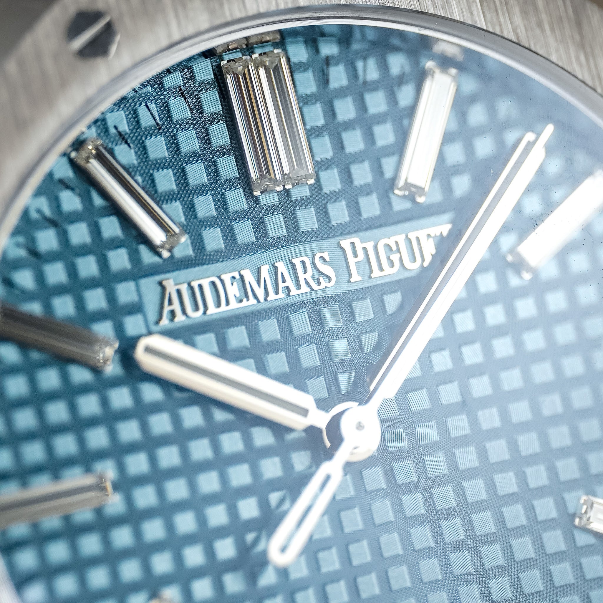 Closeup of a detailed and textured Audemars Piguet watch dial wih diamond hour markers