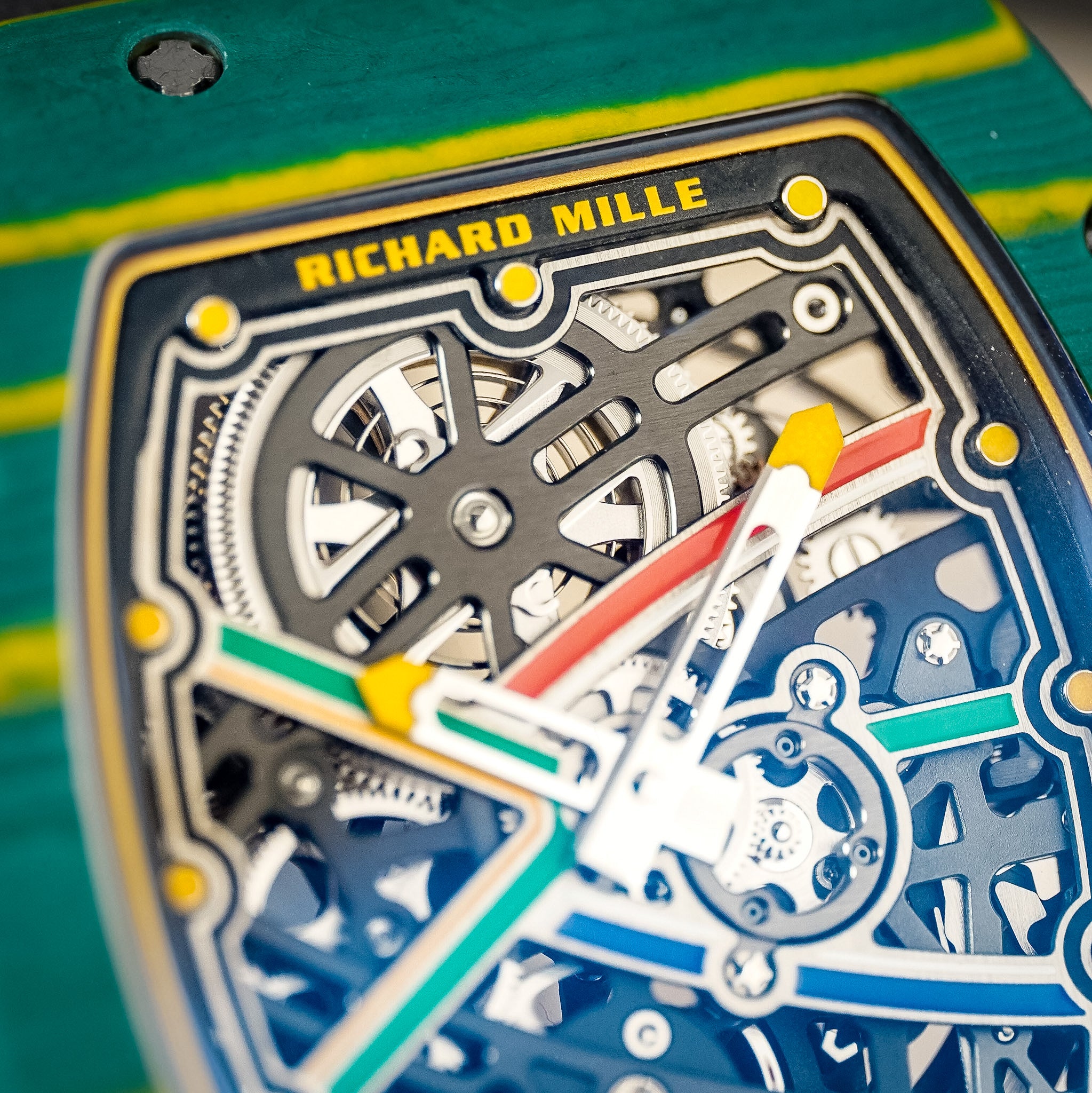 Close up of a Richard Mille watch with a vibrant green and yellow case and a skeleton dial with red, green, blue, and yellow accents.