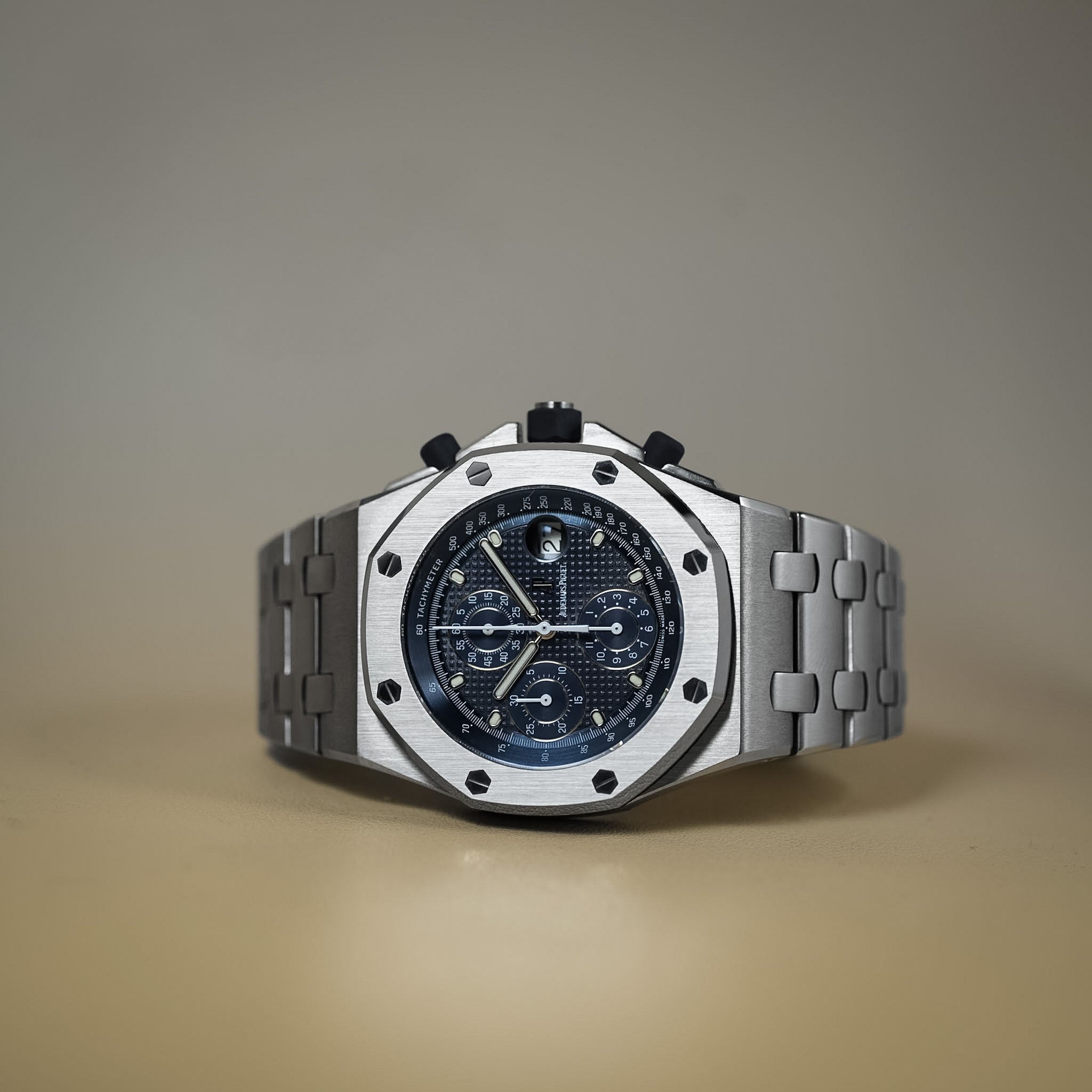Silver watch with a detailed face on a gradient background