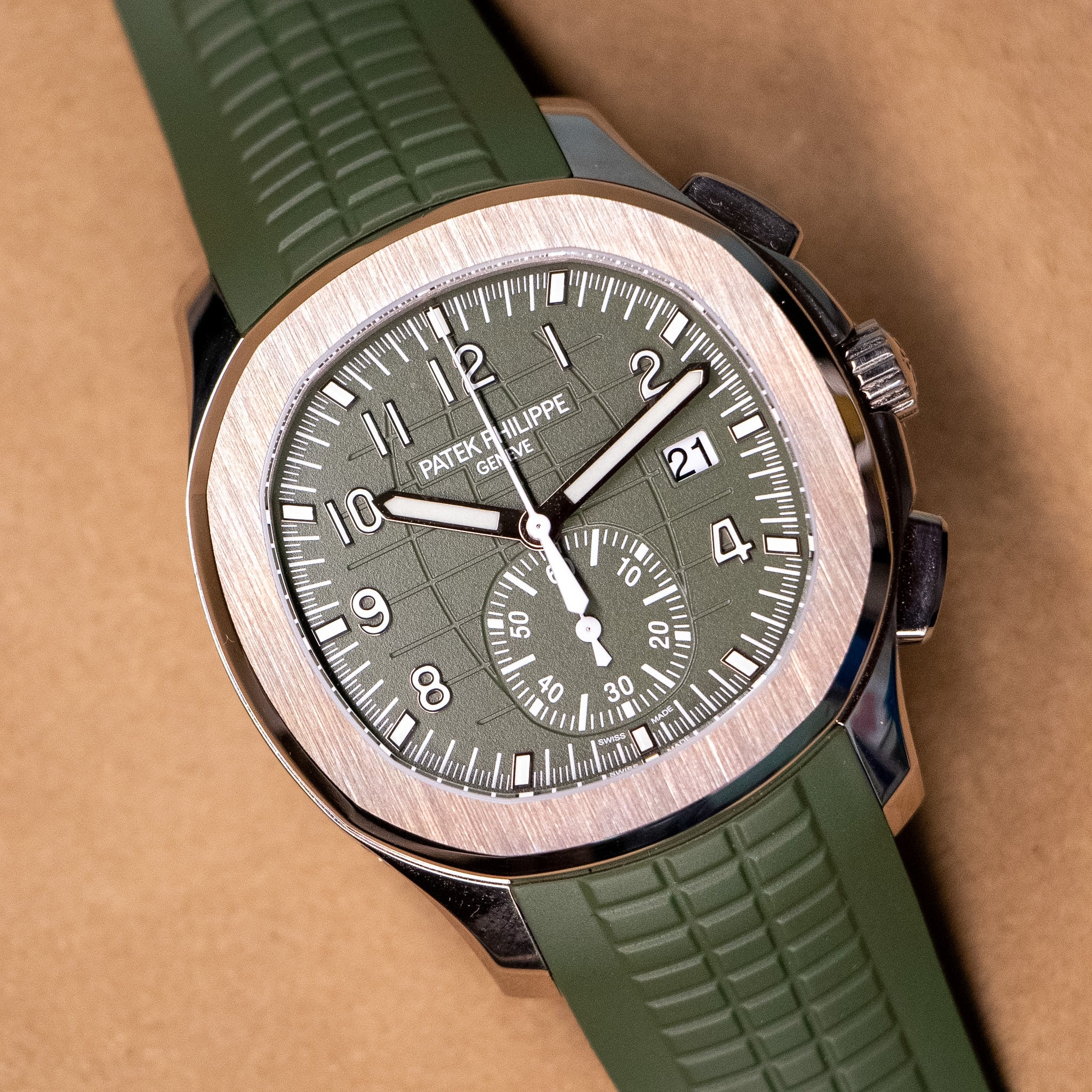 A white gold Patek Philippe Aquanaut chronograph with a green dial and a matching green strap