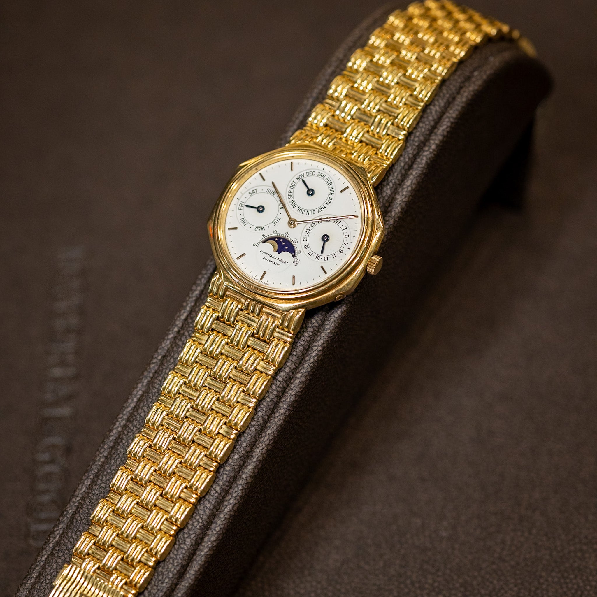 18K yellow gold Audemars Piguet 36mm Perpetual Calendar watch with white dial, moonphase, and woven gold bracelet.