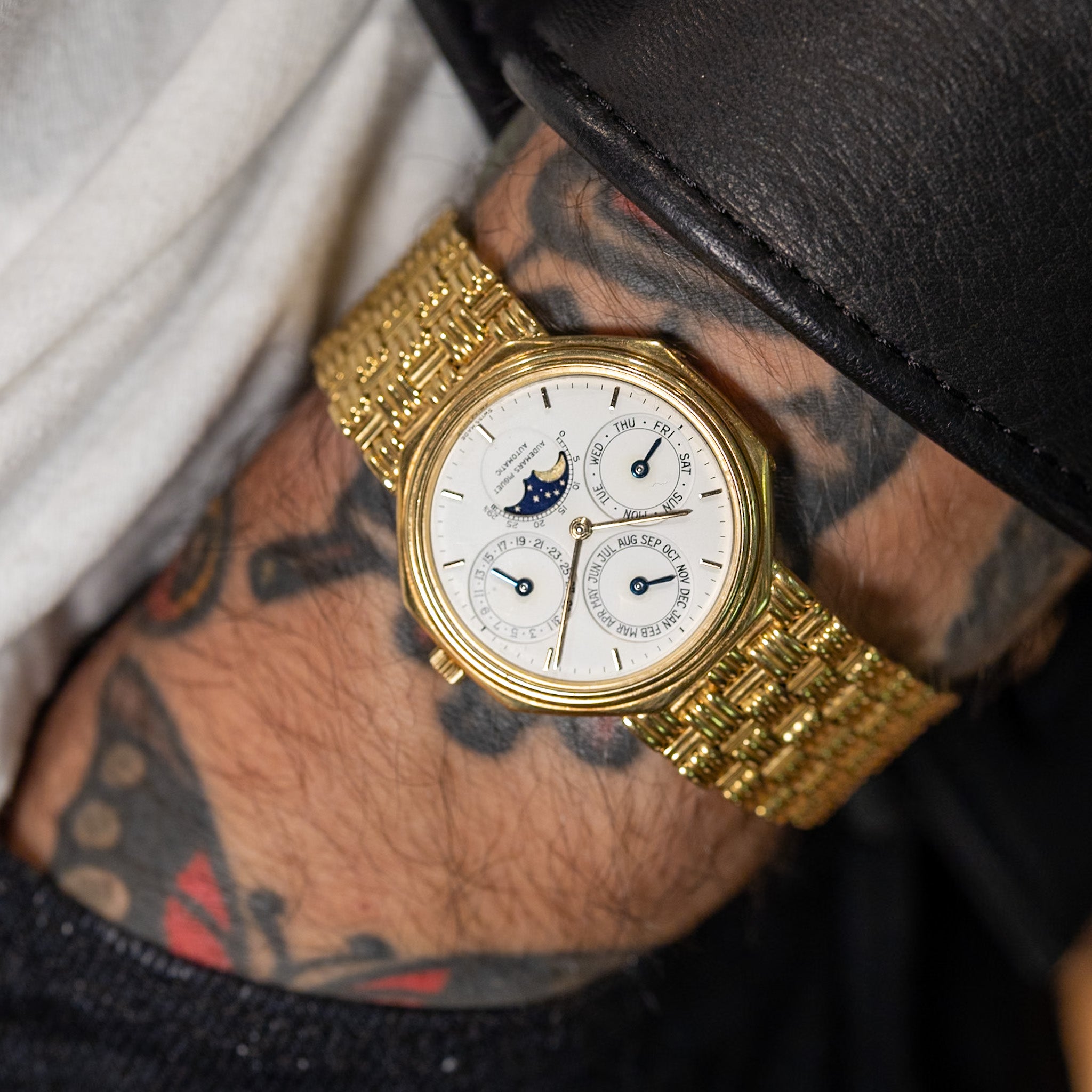 18K yellow gold Audemars Piguet 36mm Perpetual Calendar watch with white dial, moonphase, and woven gold bracelet.