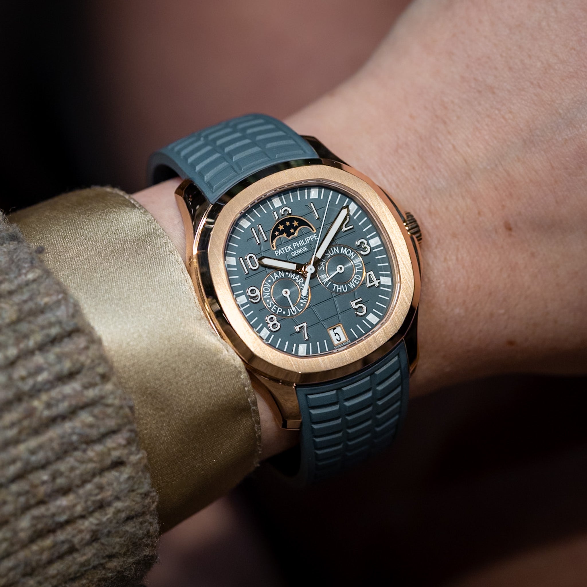 rose gold watch with a blue strap on a model's wrist