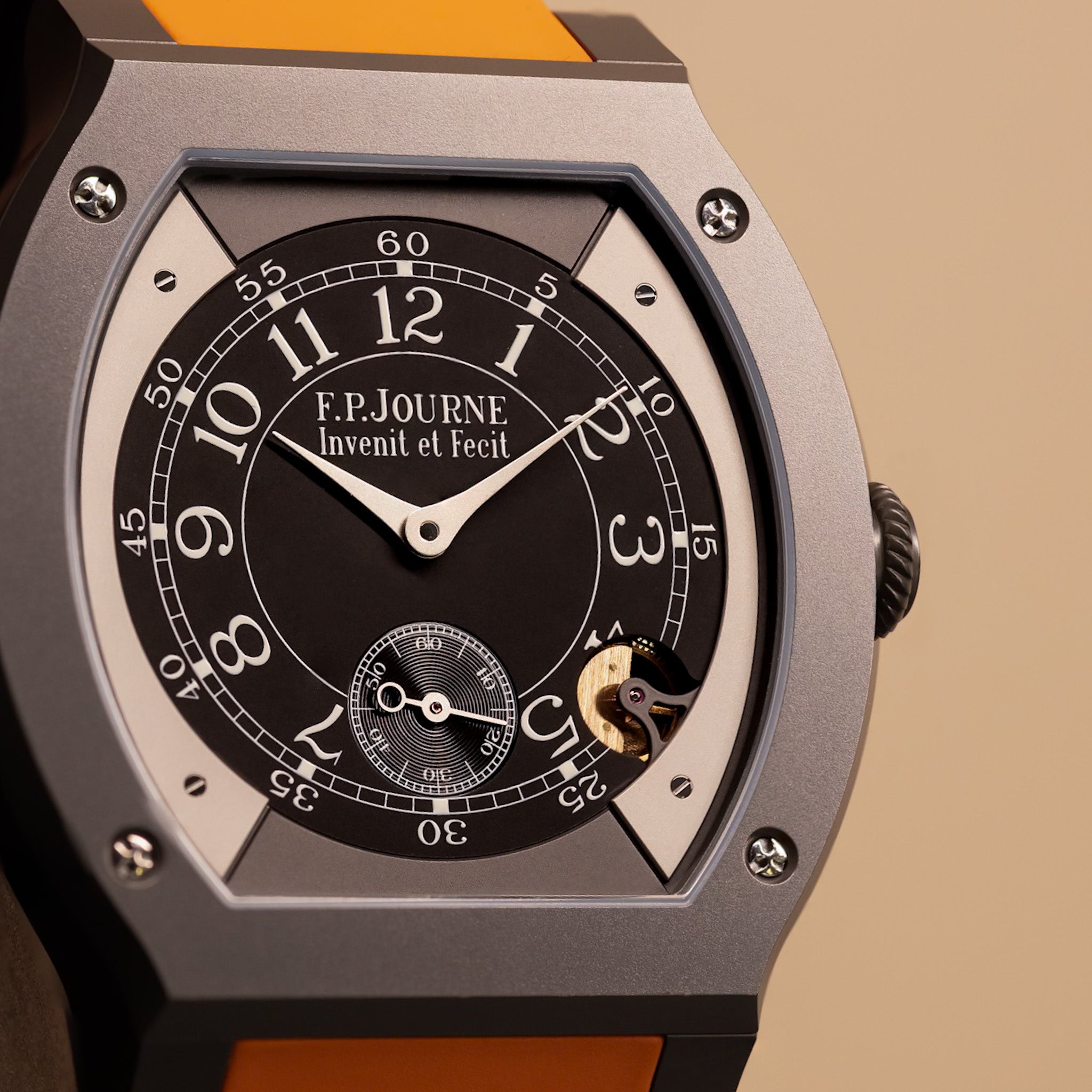 A closeup photo of a black dial F.P.Journe Elegante on a cream background