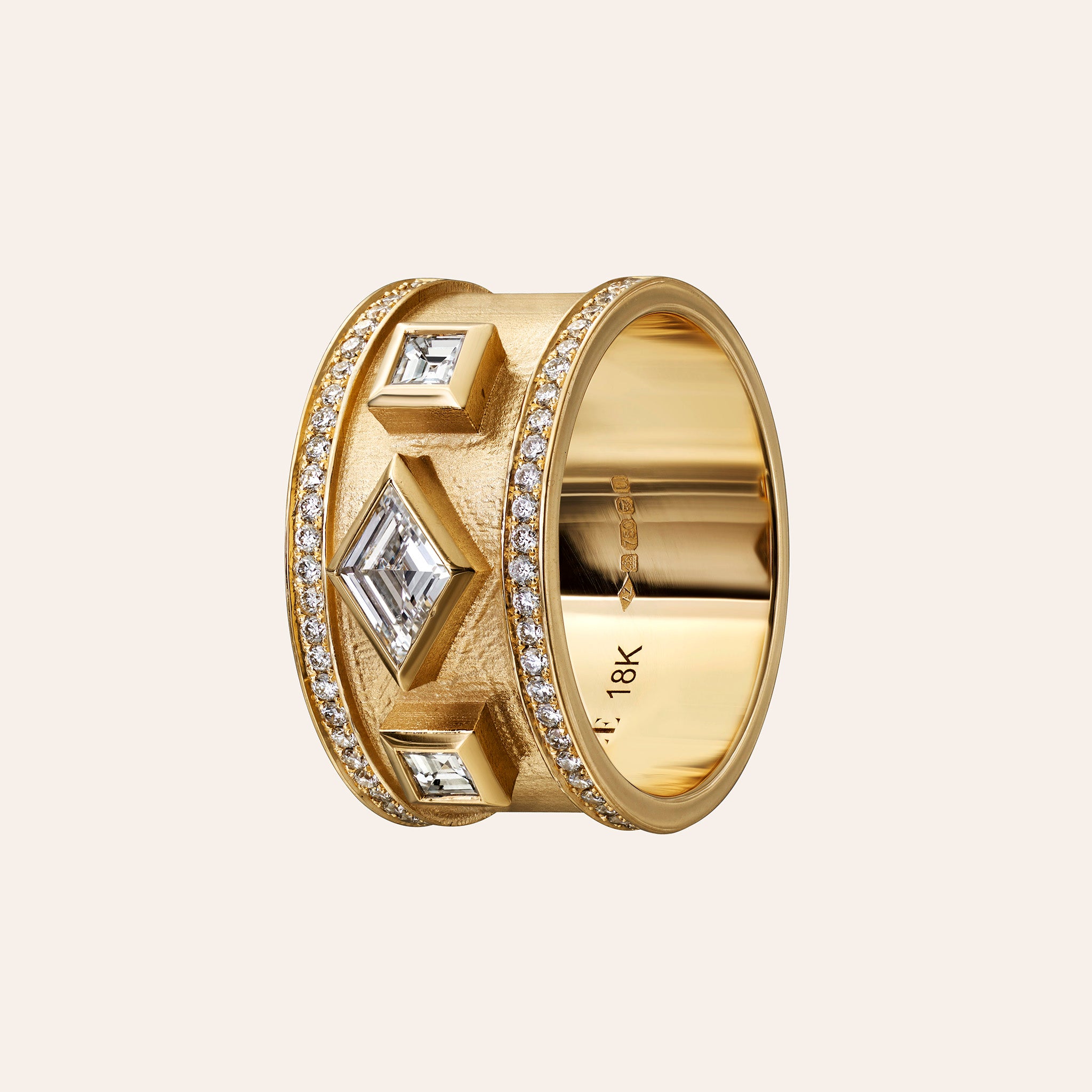 Āzlee Lozenge Diamond Ring in 18K yellow gold on an ivory background, side view of the pavé-lined wide band