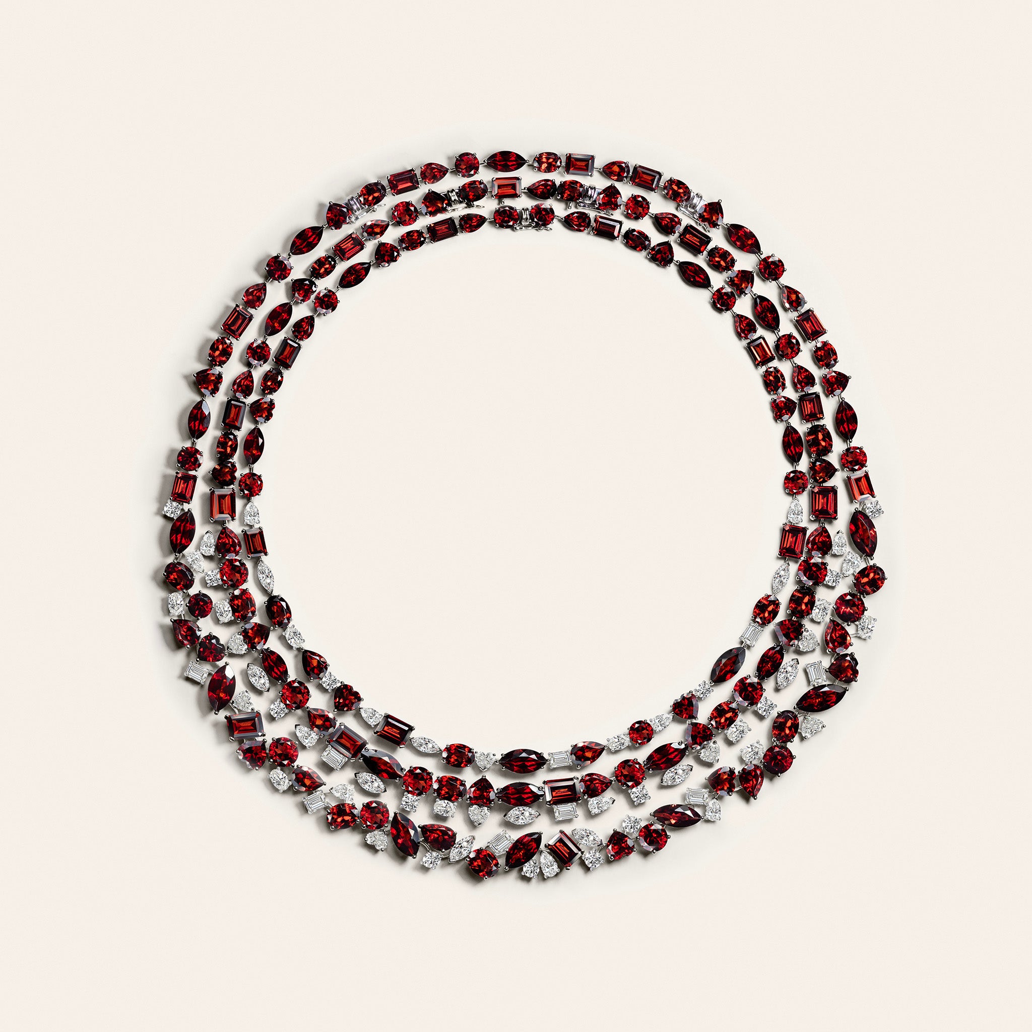 Three layered garnet and diamond necklaces in 18K white gold featuring vivid multi-shape deep red garnets and brilliant white diamonds in graduated tennis-inspired designs inspired by the red clay courts of Roland Garros Paris.