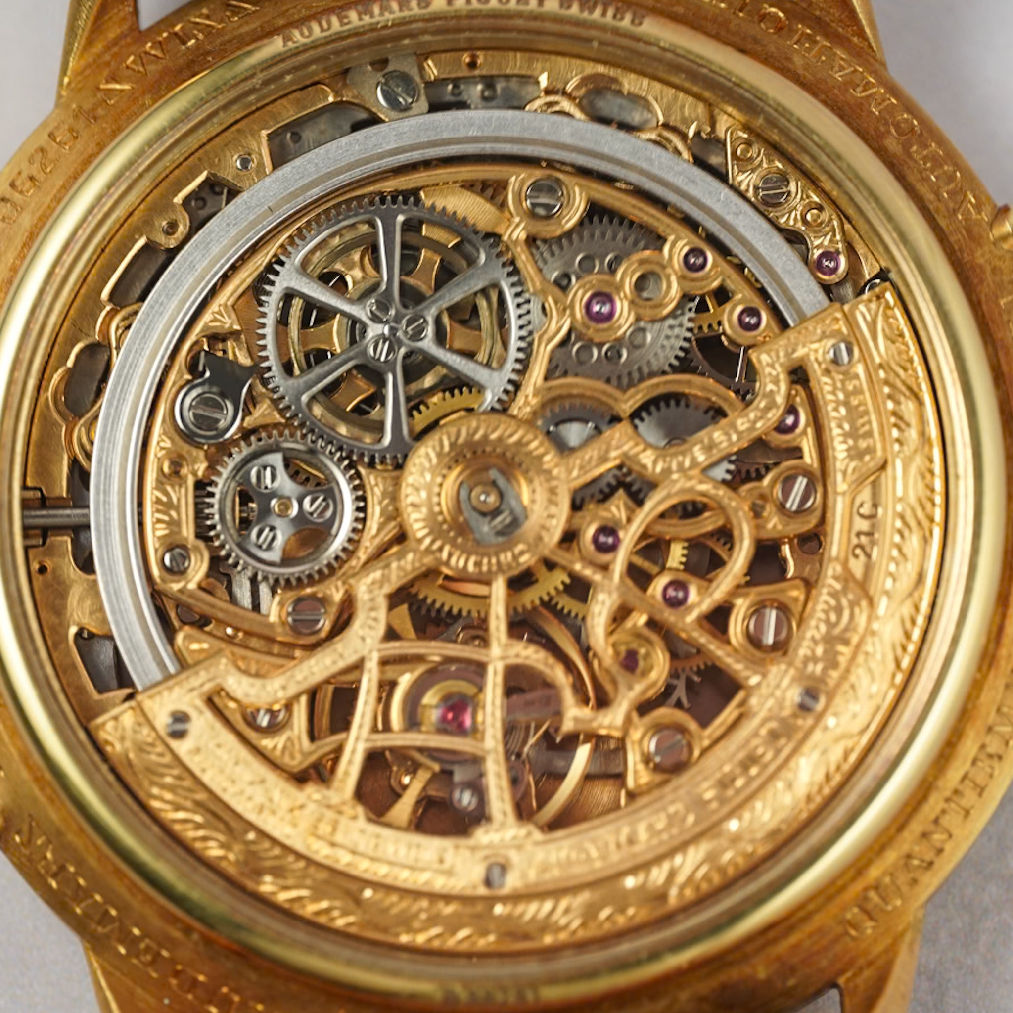 Close-up of a gold mechanical watch with intricate gears and components.