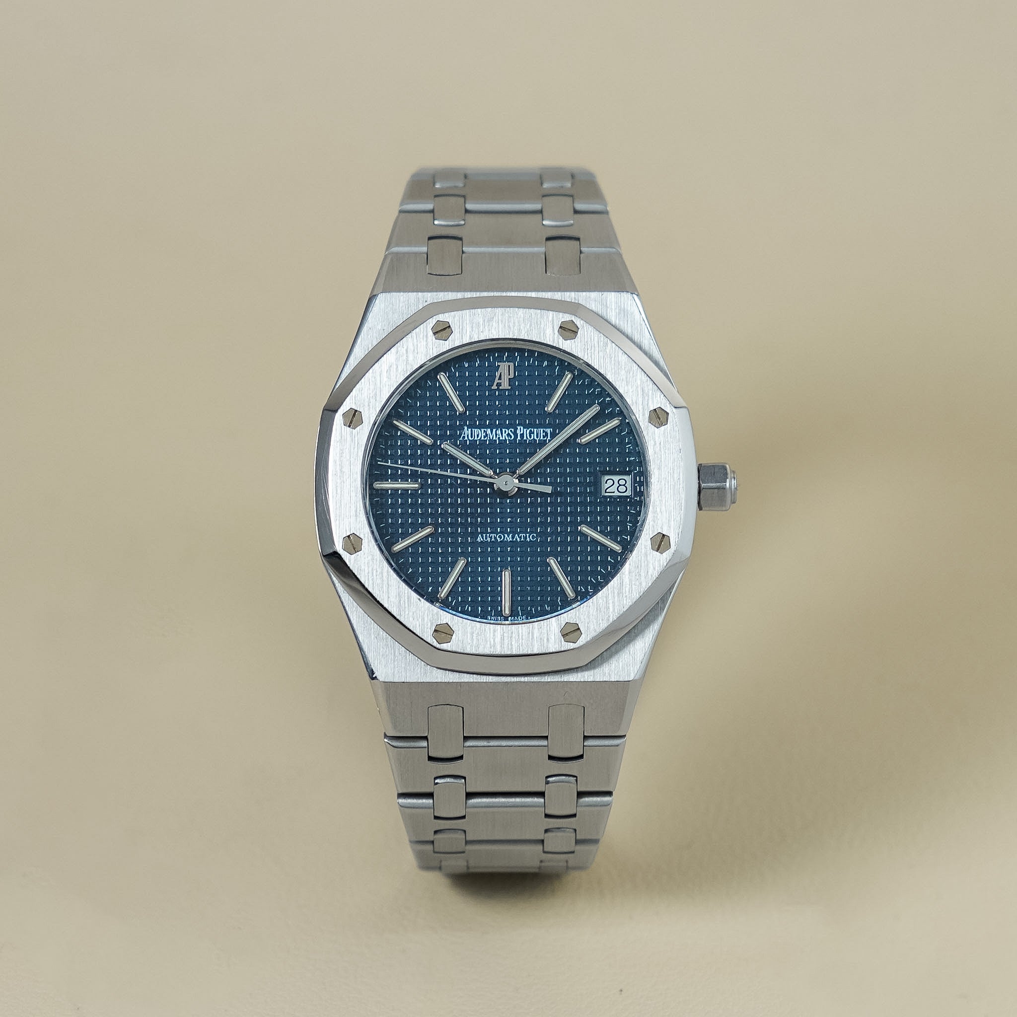 Steel watch with a blue dial on a cream background