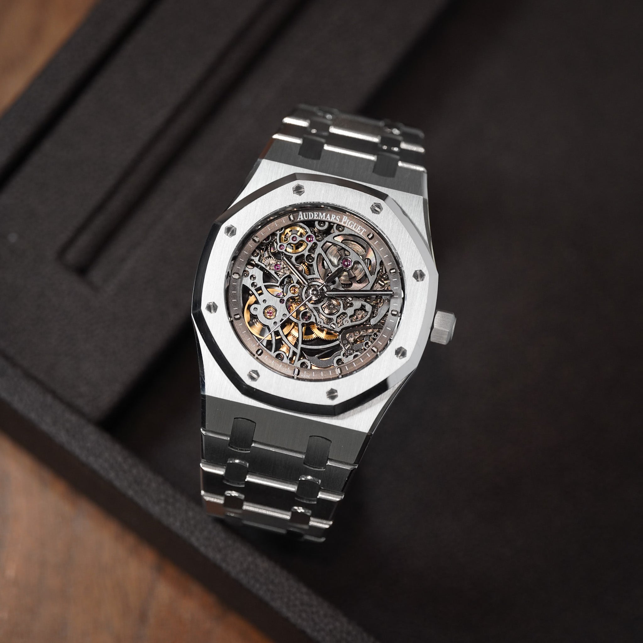 Luxury watch with mechanical components on a dark background