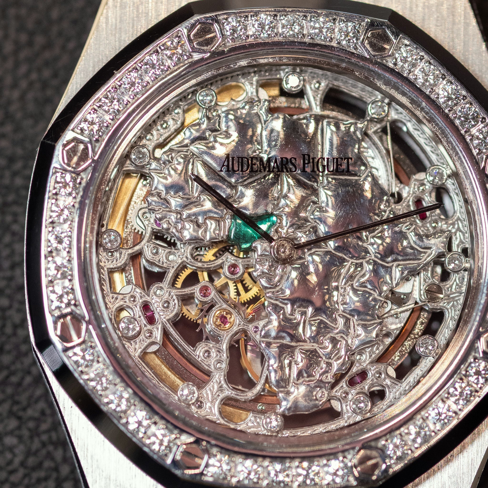 Close-up of a luxury watch with visible brand name, intricate design, and diamond-studded bezel.