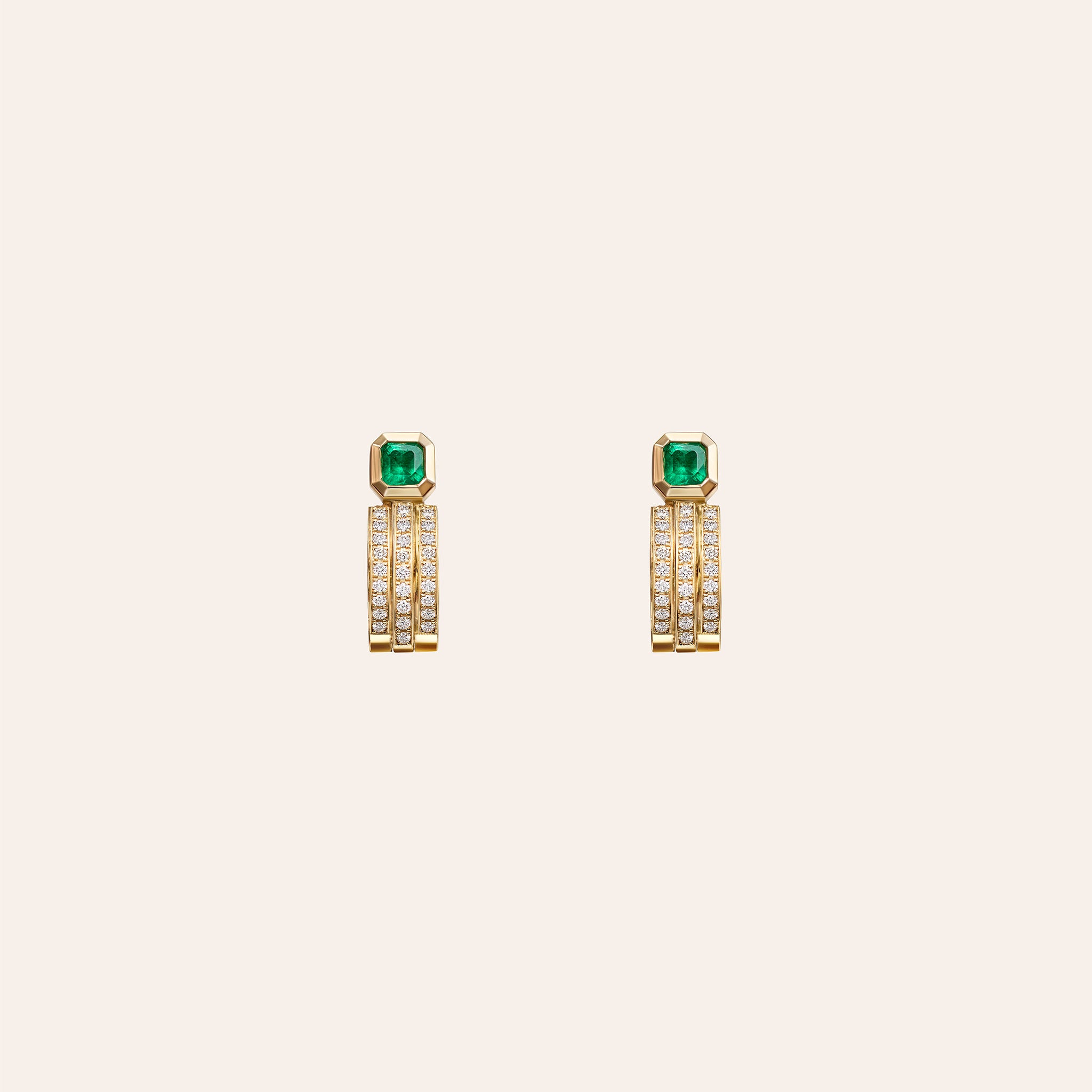 Āzlee x Gemfields Staircase 3-Tier Pavé and Emerald Hoops in 18k yellow gold with pavé-set diamonds and a bezel-set Zambian emerald, shown on an ivory background.