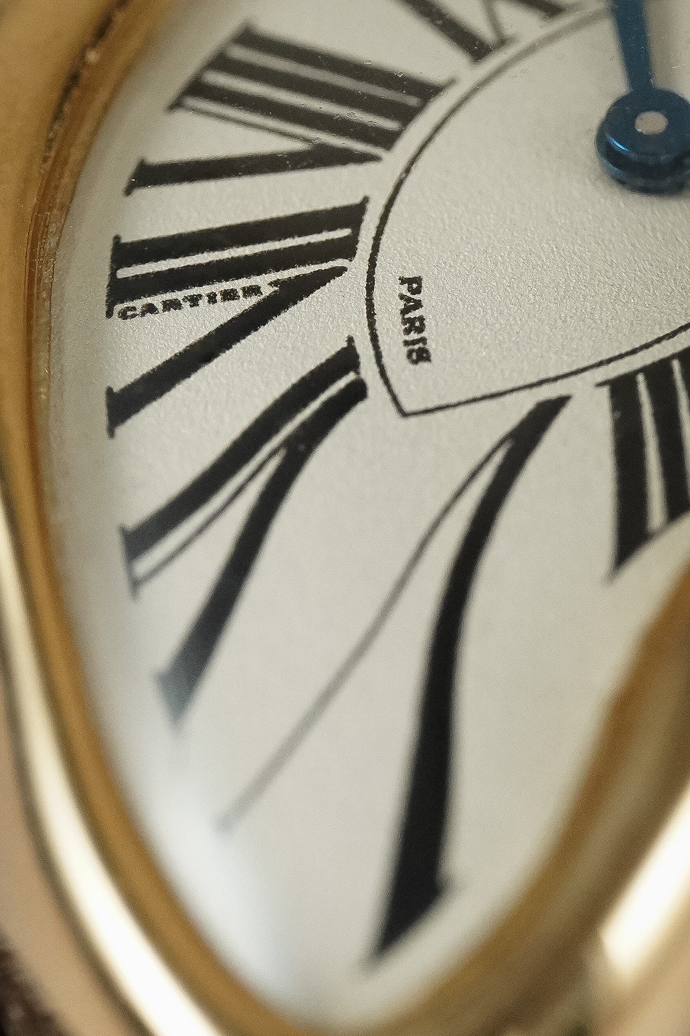 Closeup shot of a Cartier watch with roman numerals