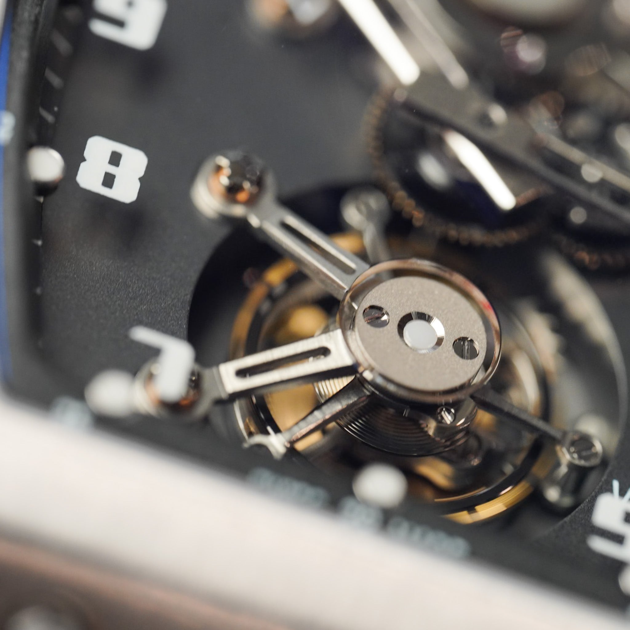 Close-up of a watch mechanism with visible gears and components.