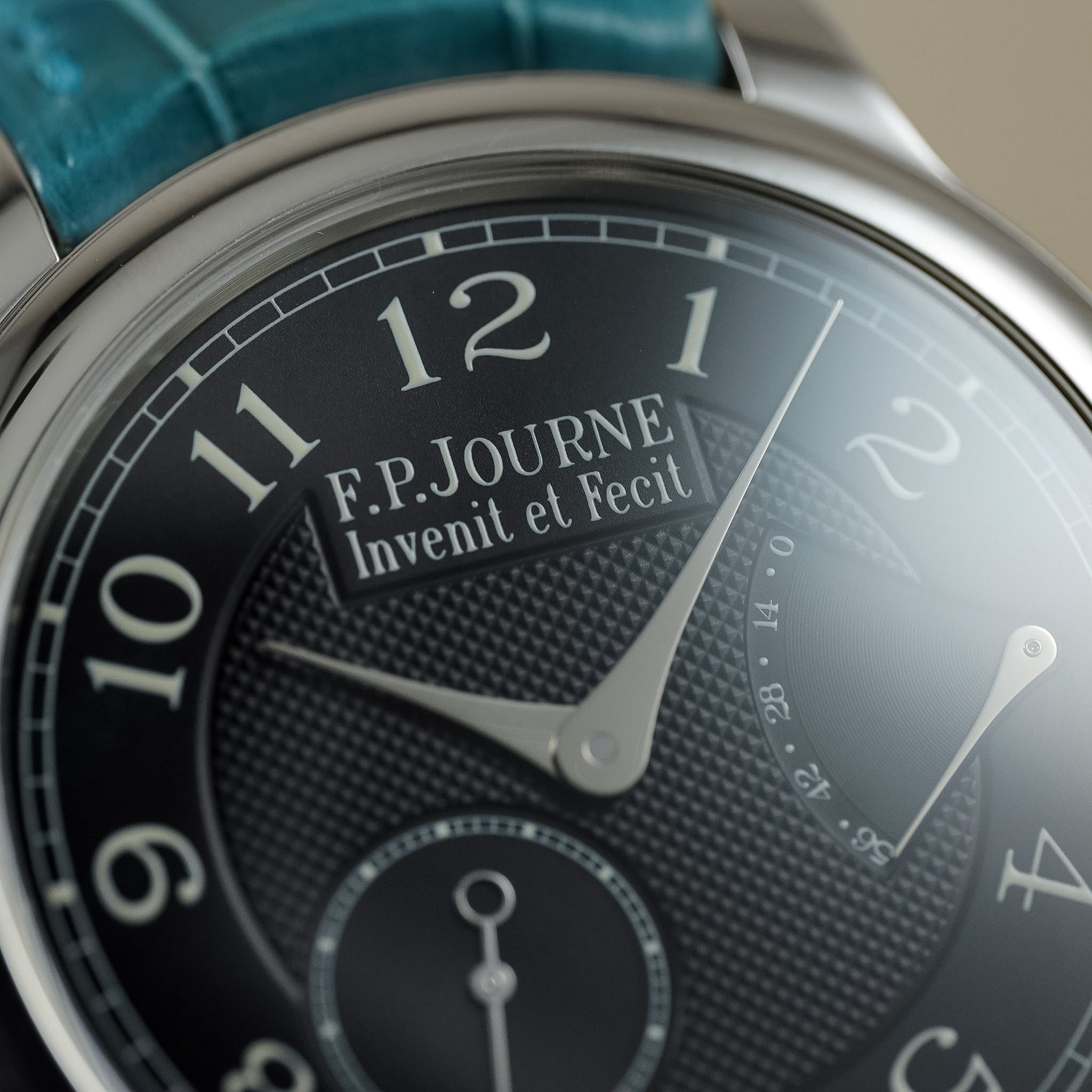 Close up of a F.P.Journe watch with a black dial and white text