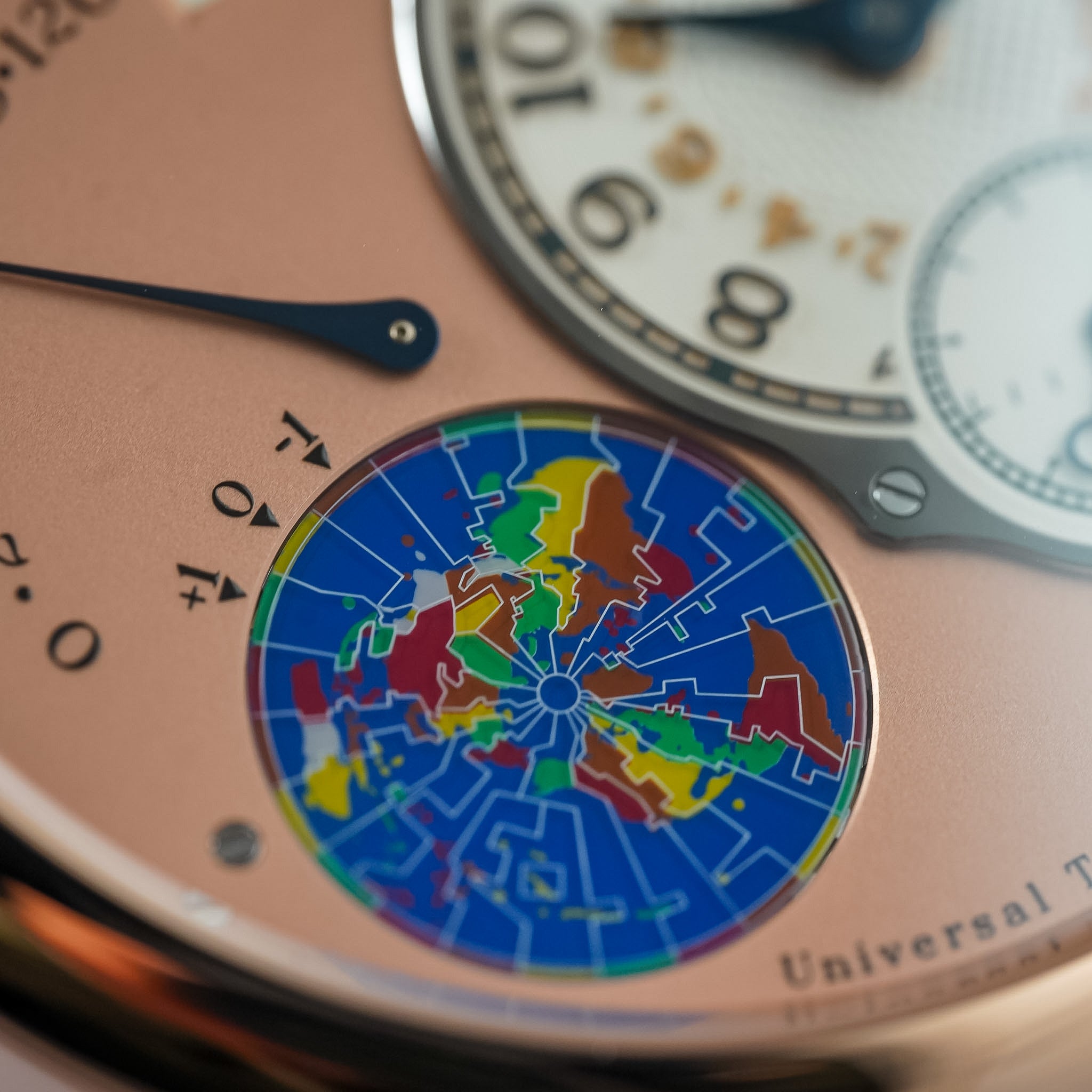 Close-up of a watch with a colorful map dial