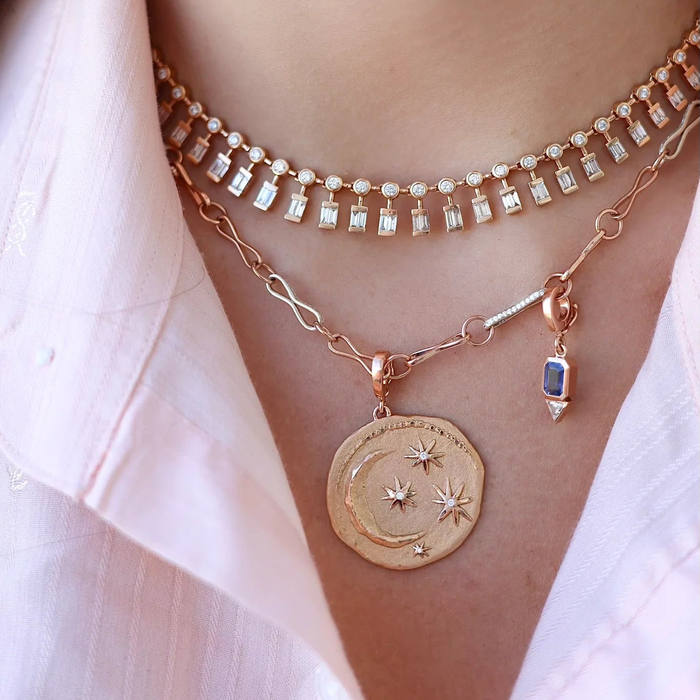 A view of the Sri Lankan saphire, its on a womens necklace along with other charms.