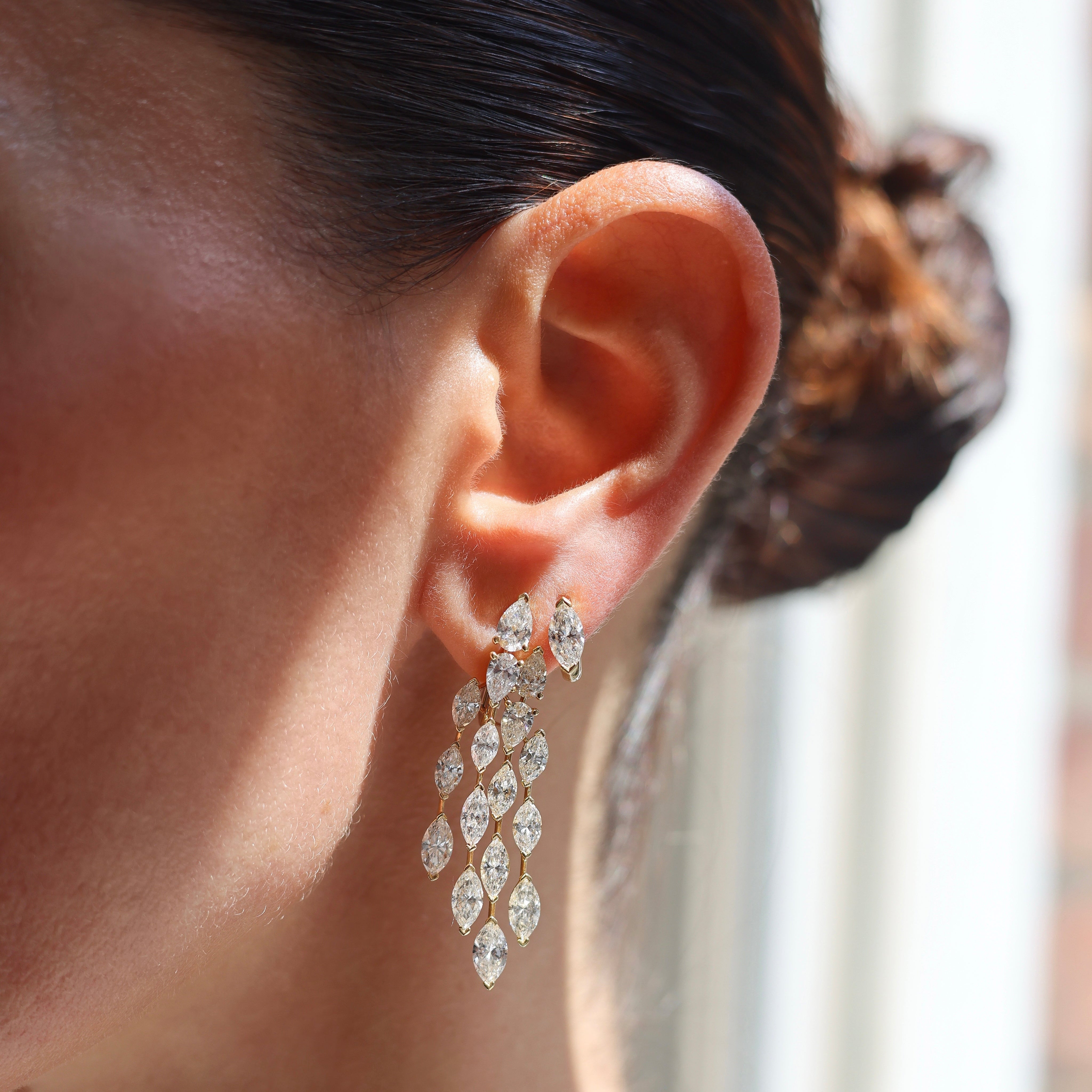 18K white gold four-row drop earrings with 10.27ct of pear and marquise diamonds in a sculptural cascading design on model 