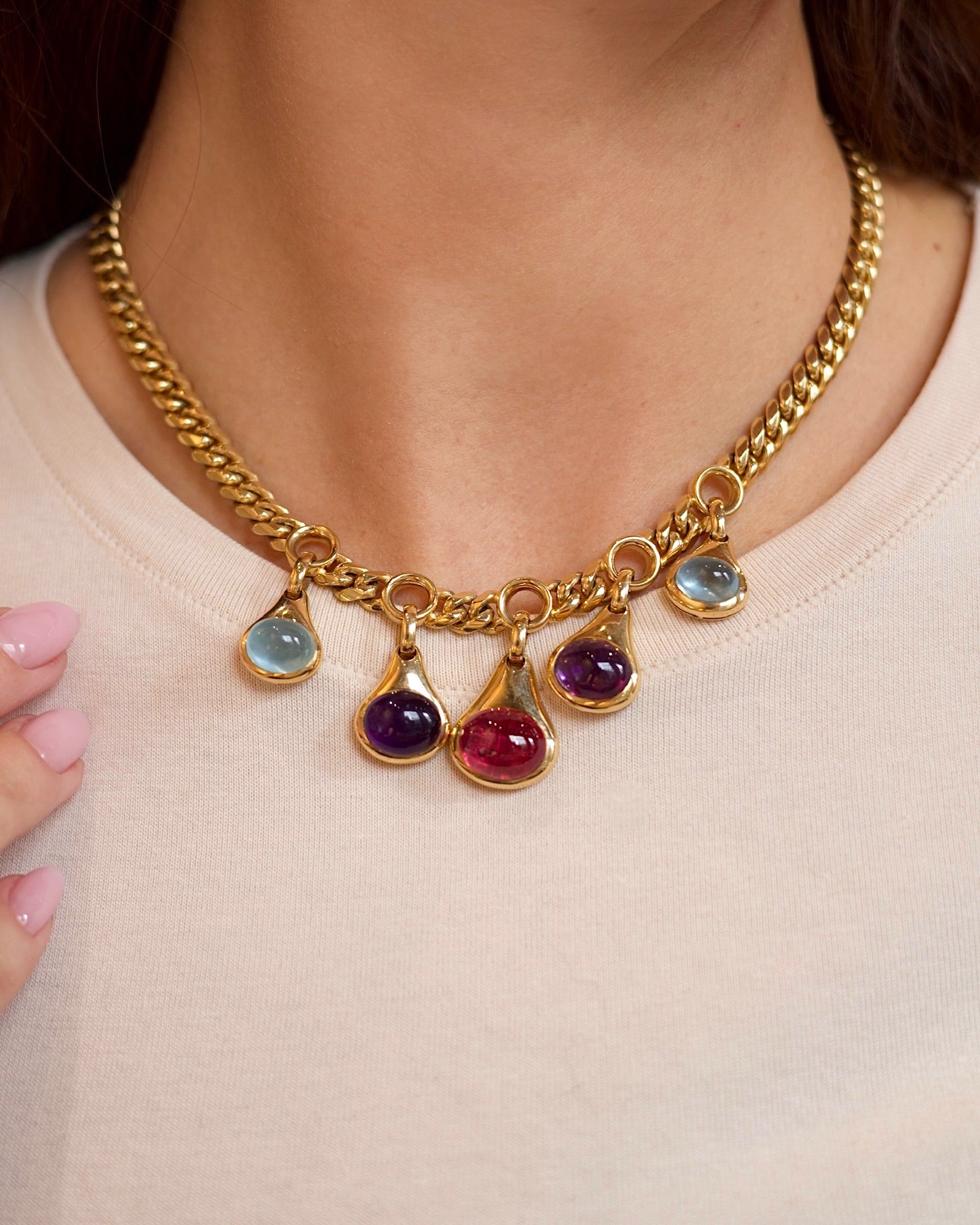 Signed vintage Bulgari 18K yellow gold curb chain necklace with five bezel-set ruby, topaz and amethyst cabochon drops on model