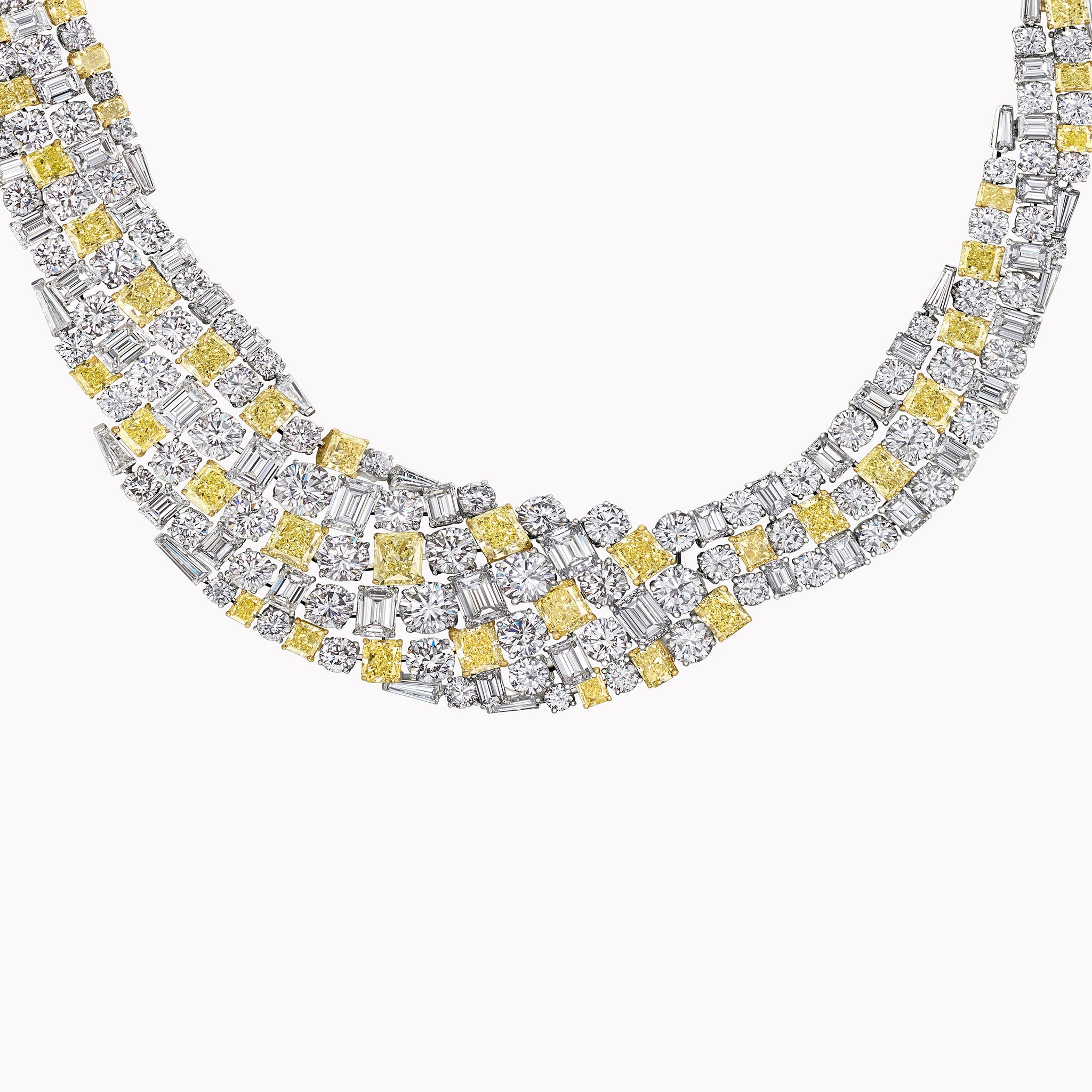 Close-up of a 102.58ct fancy yellow radiant-cut diamond necklace featuring emerald and round diamonds in 18K yellow and white gold.