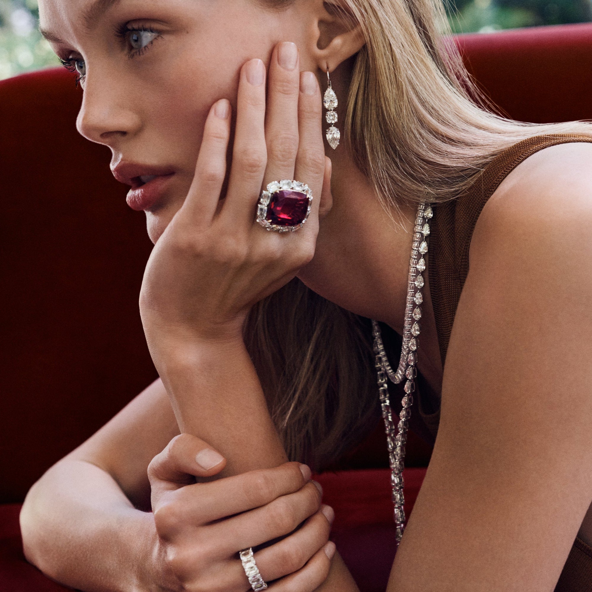 Cushion Garnet & Diamond Cocktail Ring in 18K yellow gold and platinum featuring a 34.46 carat cushion-cut garnet and 6.24 carats of antique cushion-cut diamonds.