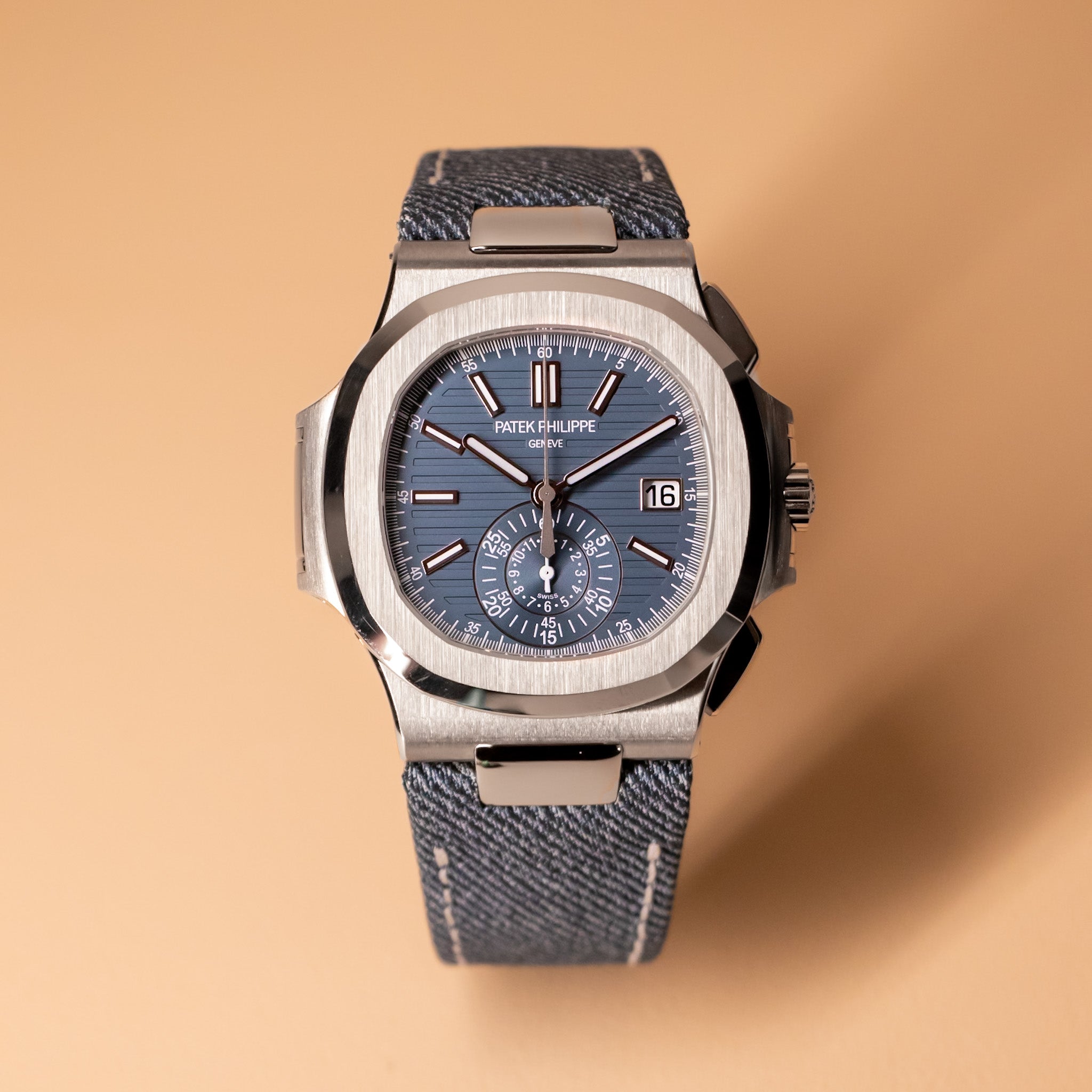 blue dial watch on a cream background