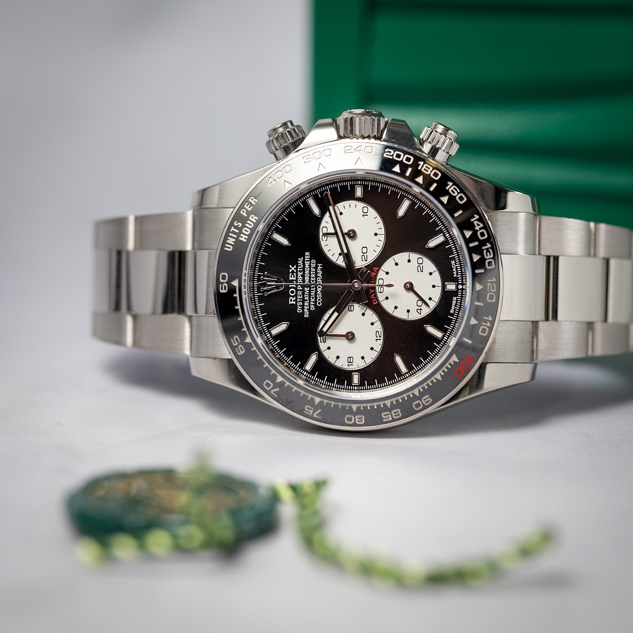 Silver and black watch with detailed face on a gray background