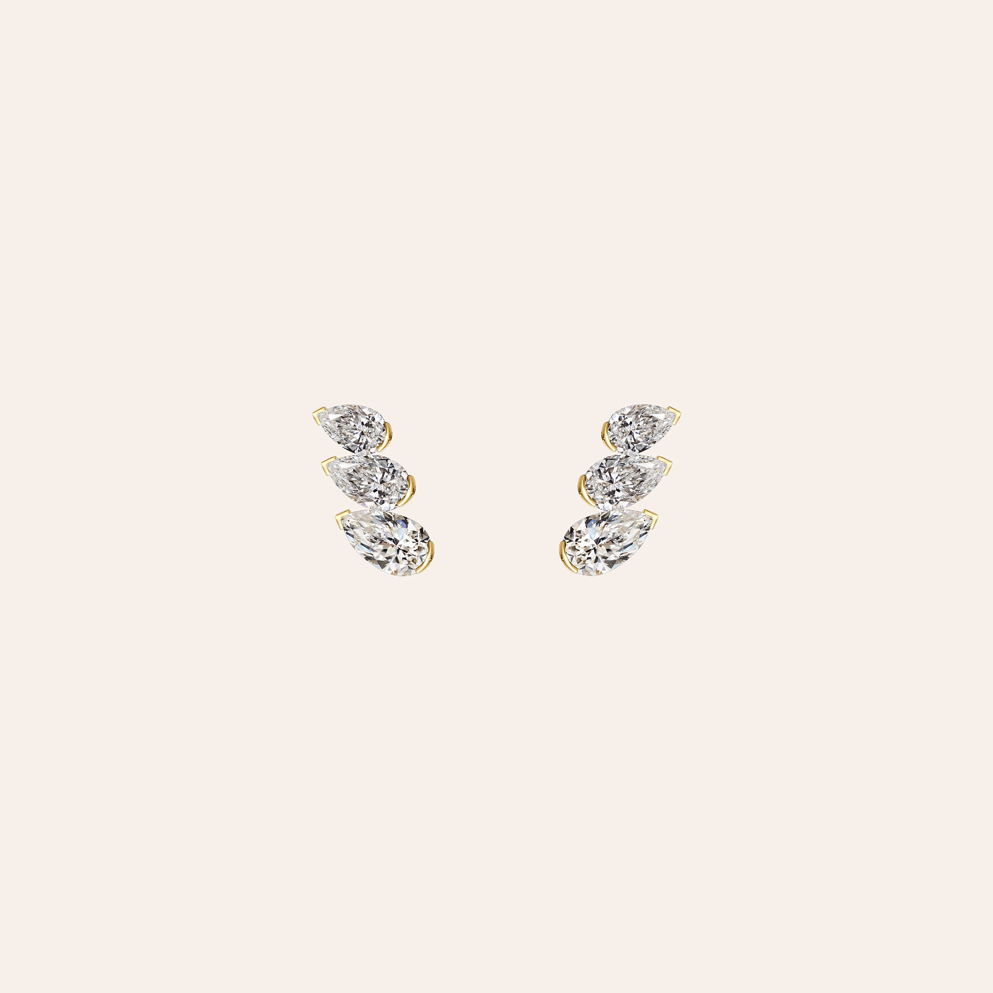 The Muse Trio Studs in 18K yellow gold with three graduated pear-shaped diamonds