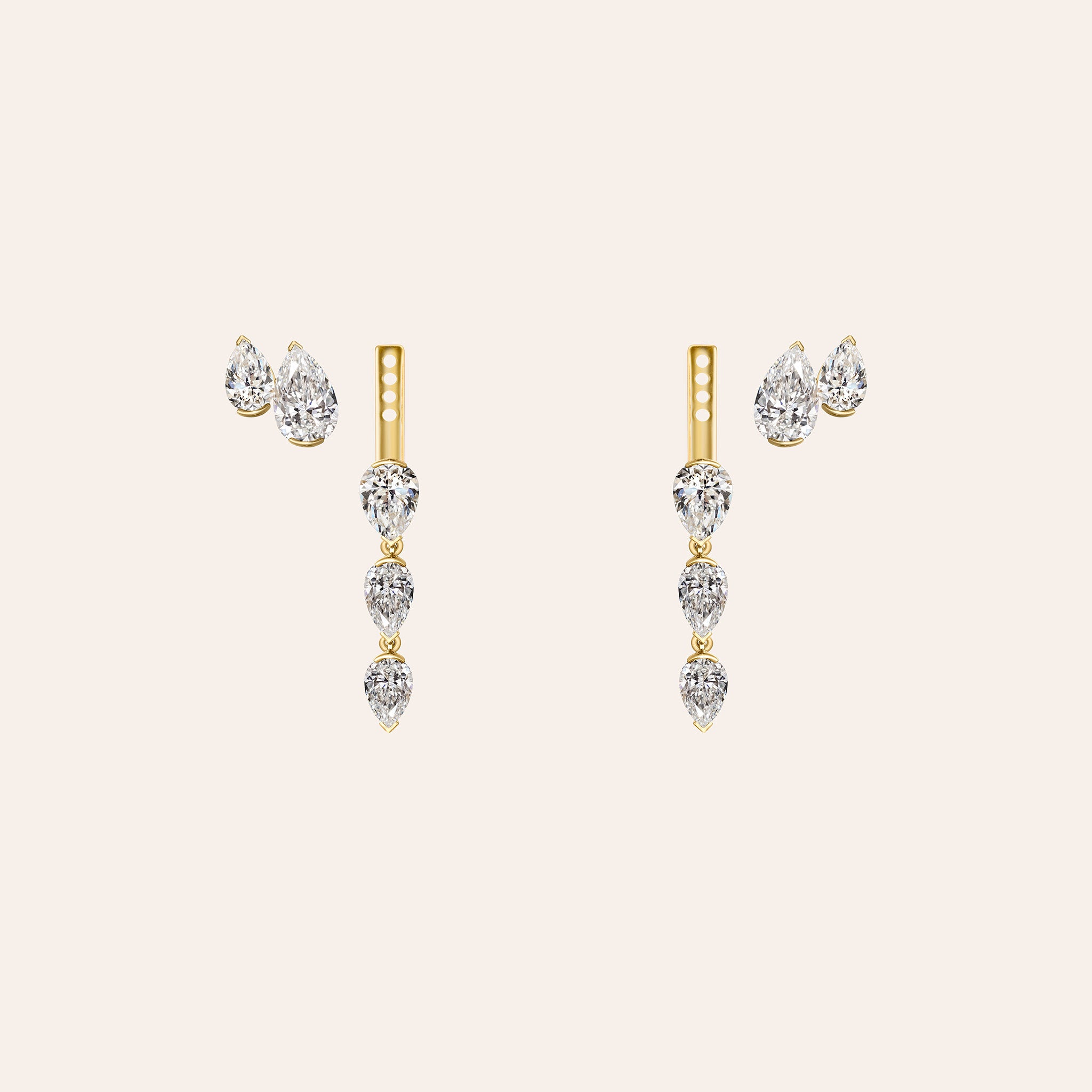 A pair of gold drop earrings with three clear pear shape diamonds in each earring, displayed on a light cream background. A pair of diamond pear shape duo alongside.