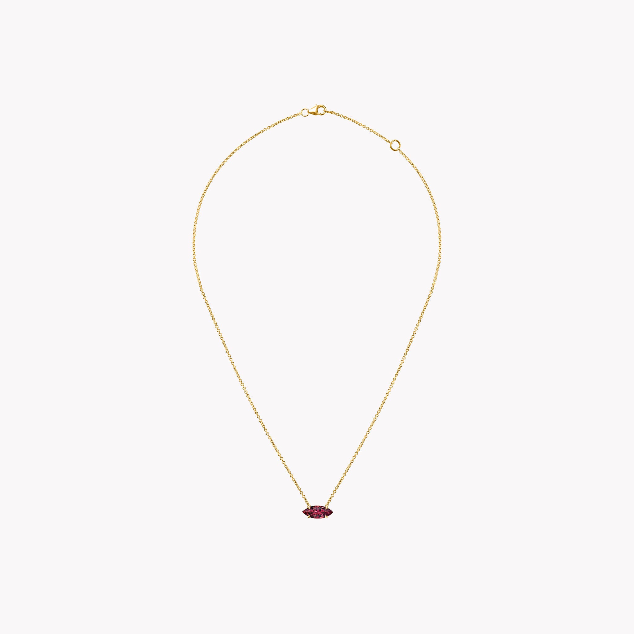 Marquise ruby pendant necklace in 14K rose gold with a four-prong basket setting on a delicate chain.