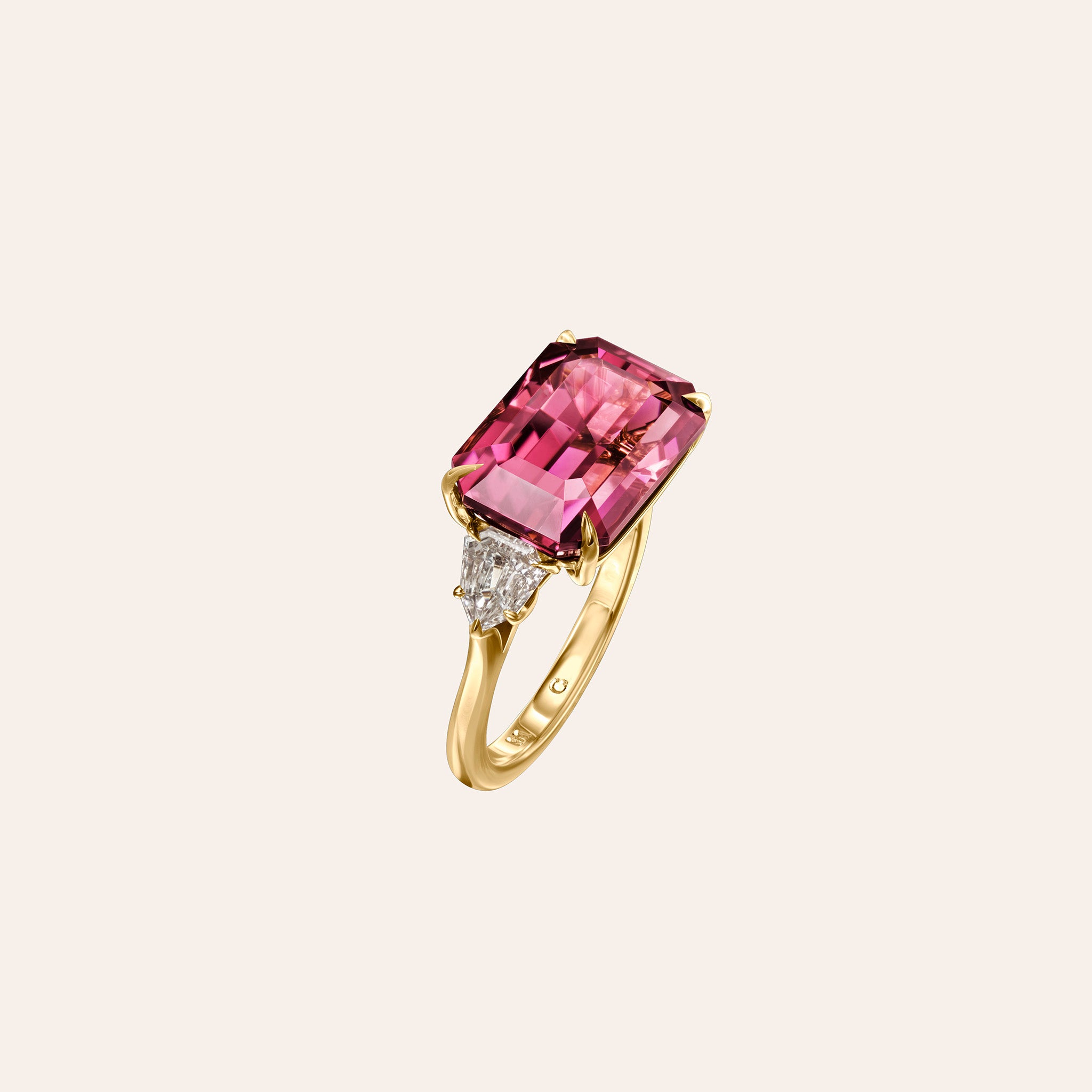 Angled view of the Aster Ring showing the pink tourmaline and shield diamonds in 18K yellow gold