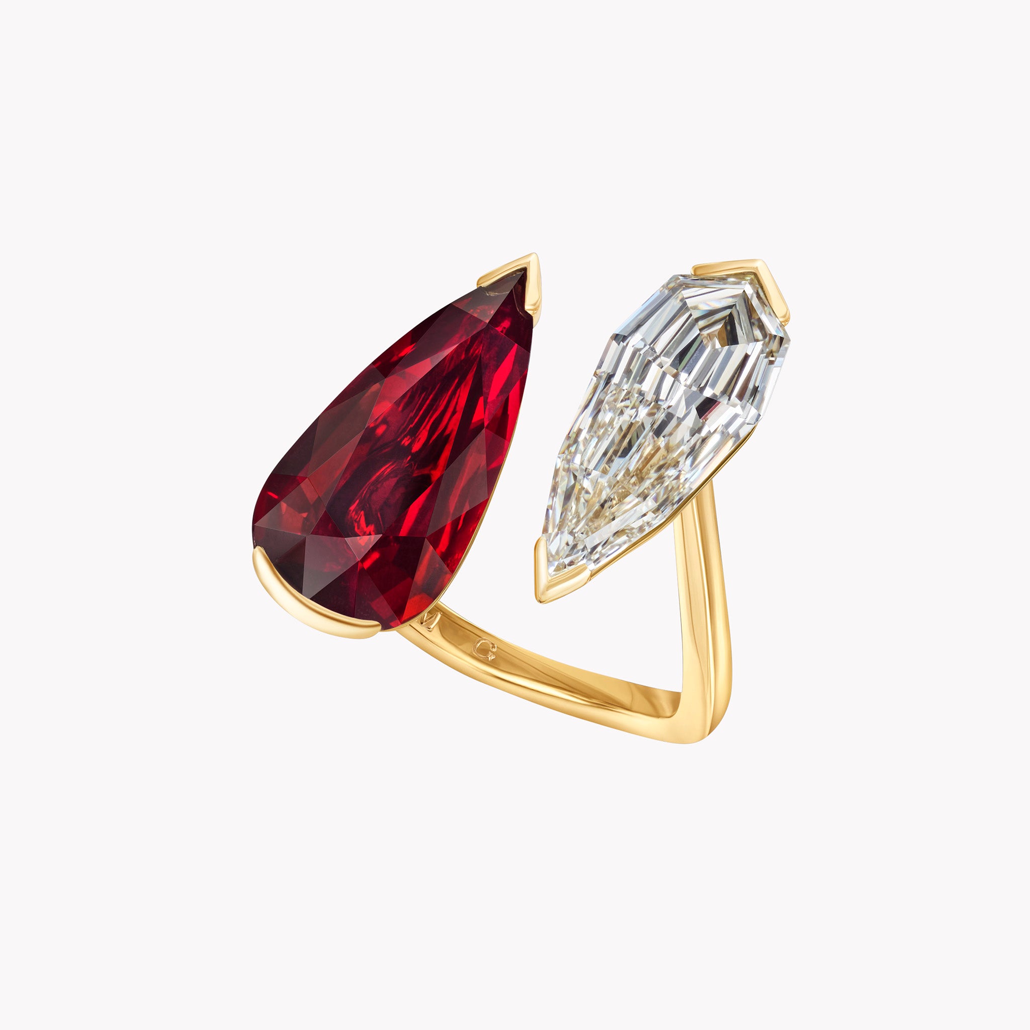 Pear shape ruby and diamond Daphne ring in 18K yellow gold featuring a Mozambique ruby and pear-shaped diamond. At an angle.