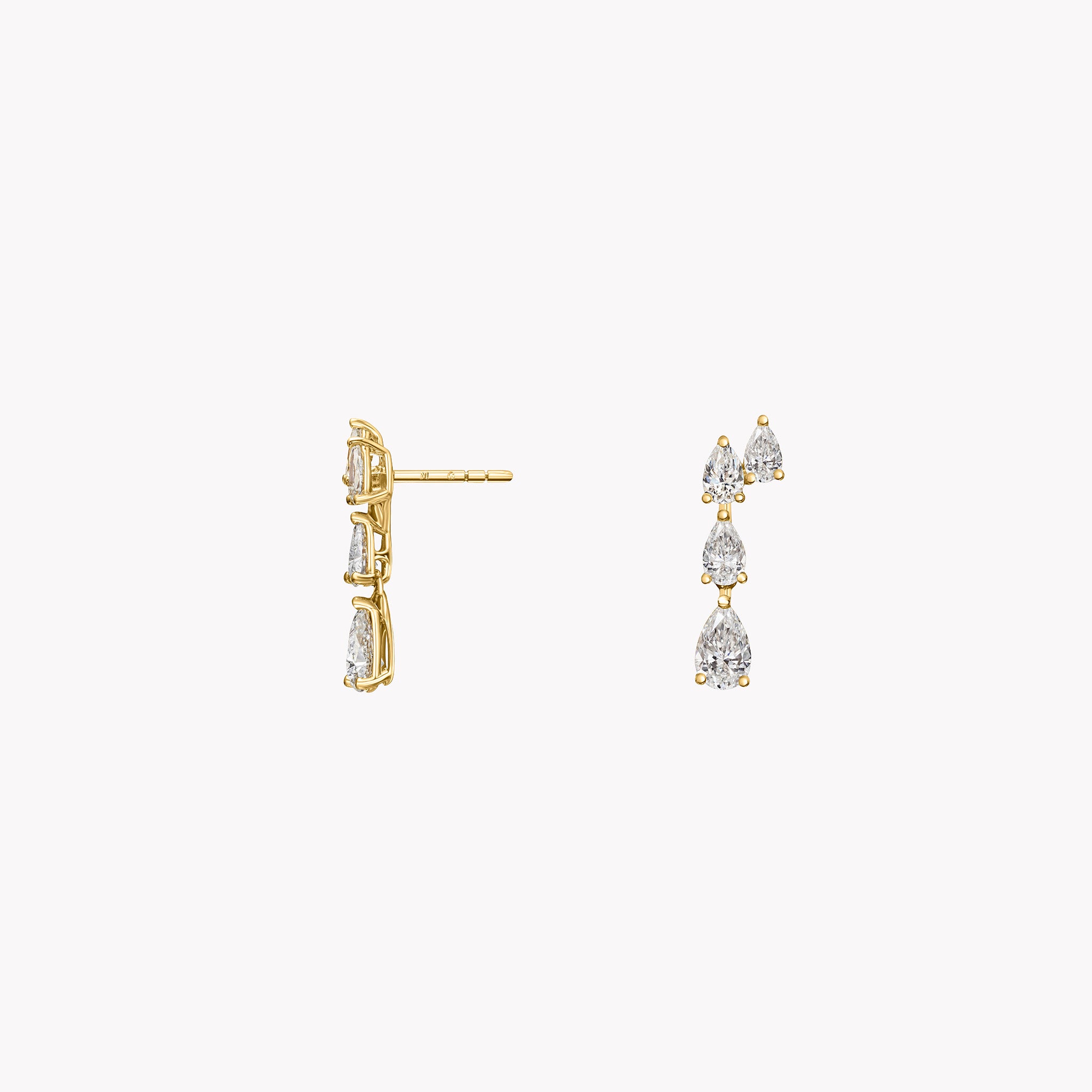 18K yellow gold drop earrings featuring cascading pear-shaped diamonds in a modern graduated silhouette. Side view.