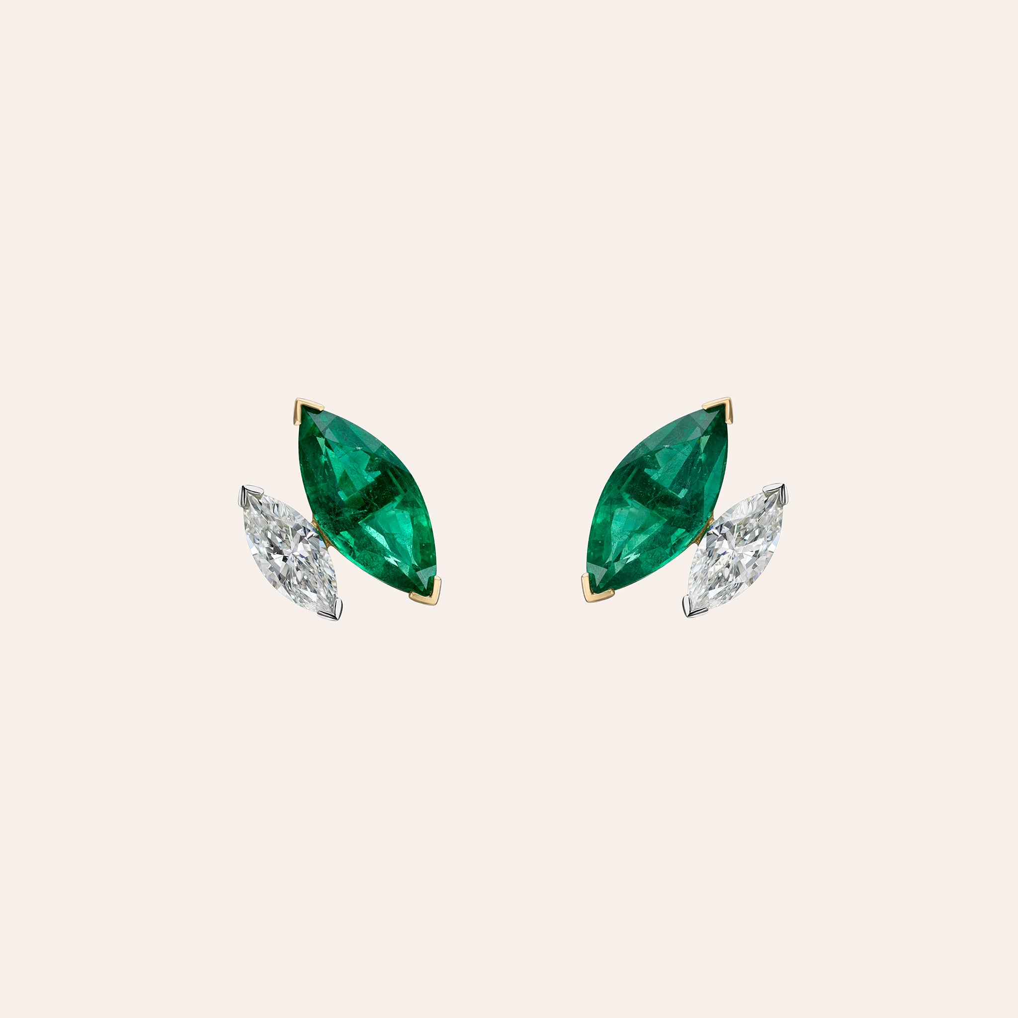 Marquise emerald and diamond stud earrings in 18K yellow and white gold shown in slanted position