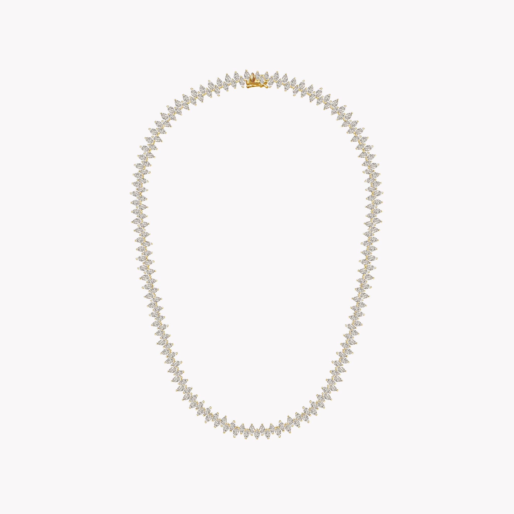 Marquise Diamond Yellow gold necklace on a light coral background