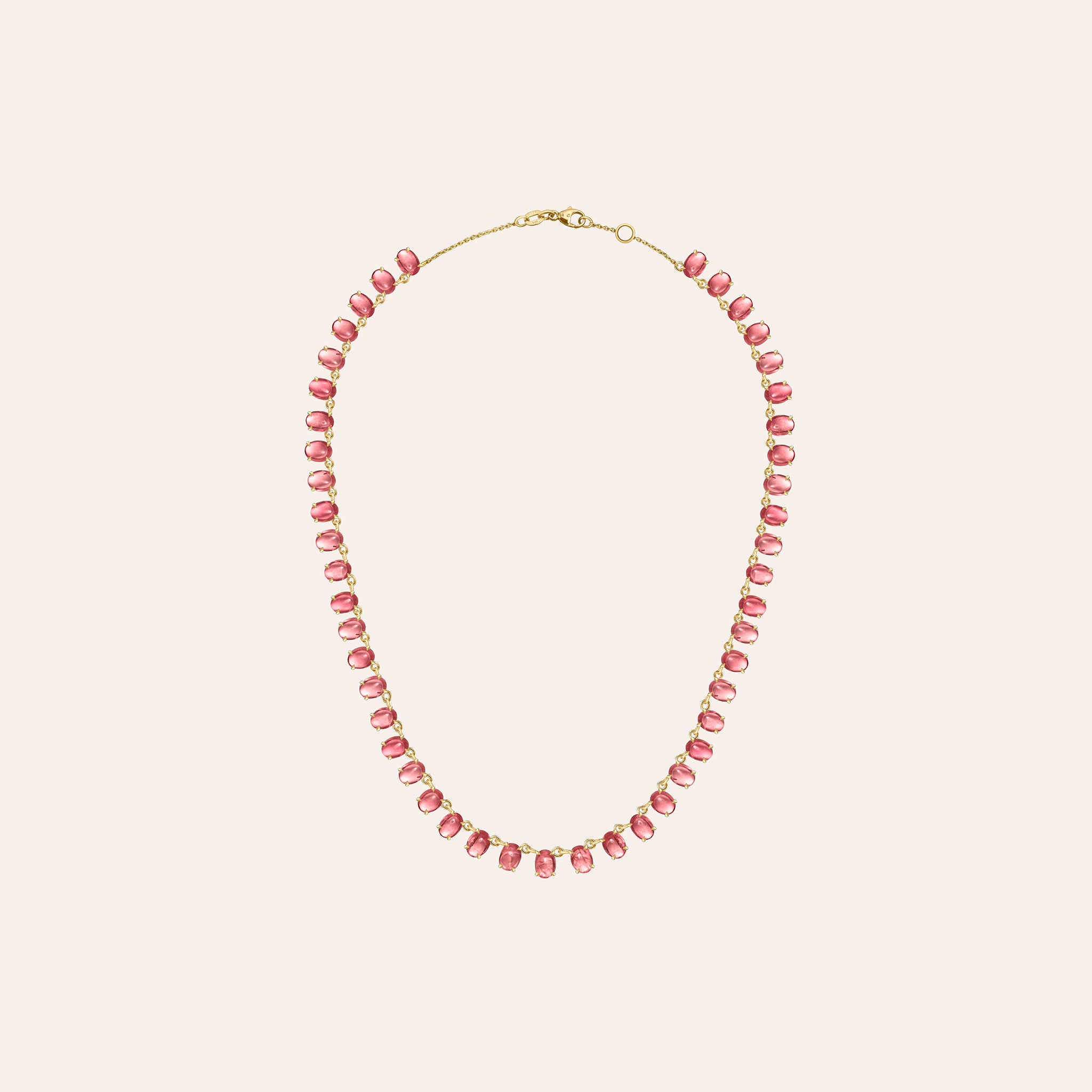Alternate view of The Lena Peach Tourmaline Necklace, showing oval cabochon peach tourmalines set along a gold chain, against a cream background.