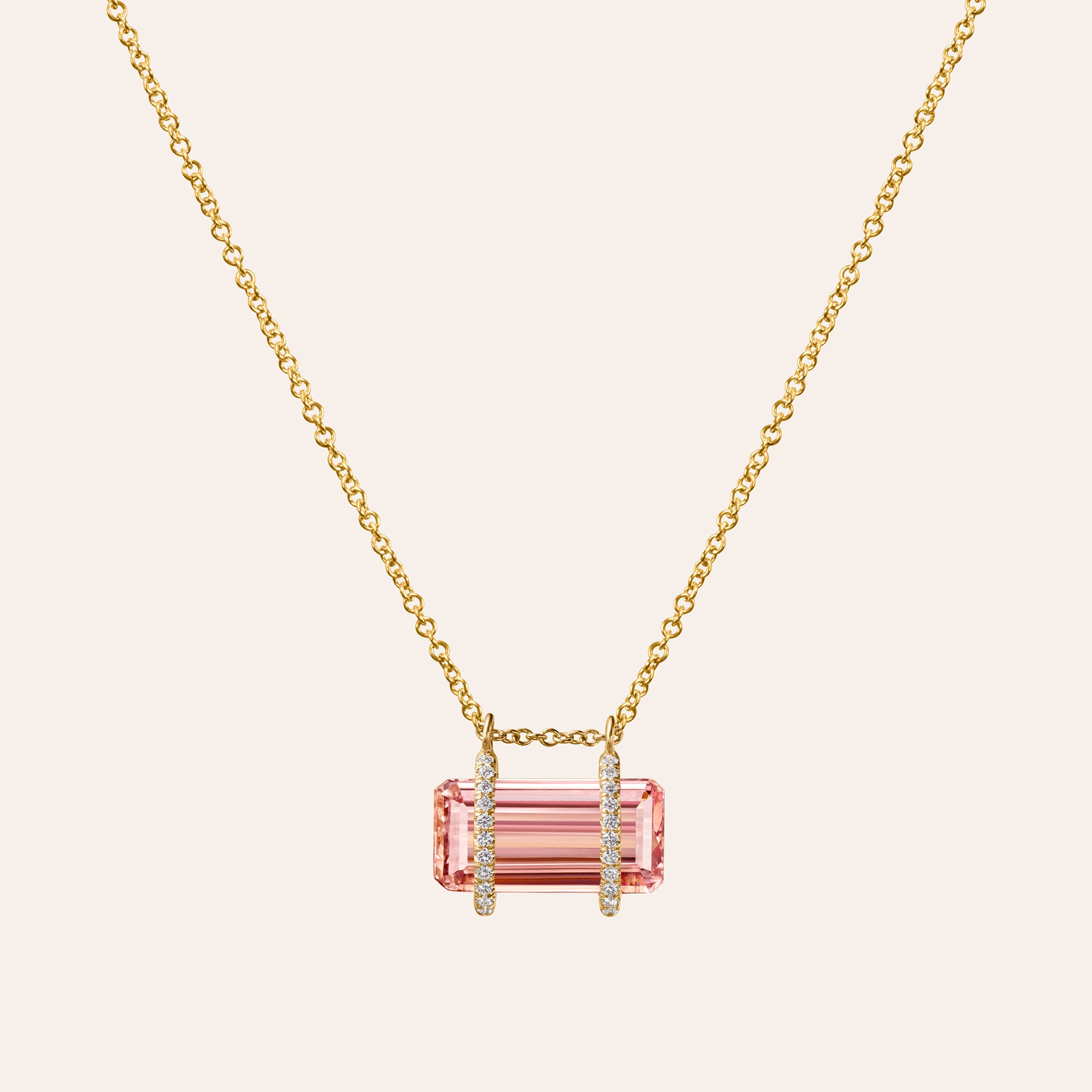 Close up of East-West Pink Topaz & Diamond Pendant Necklace in 18K gold, with a horizontal emerald-cut pink topaz flanked by two pavé diamond bars.