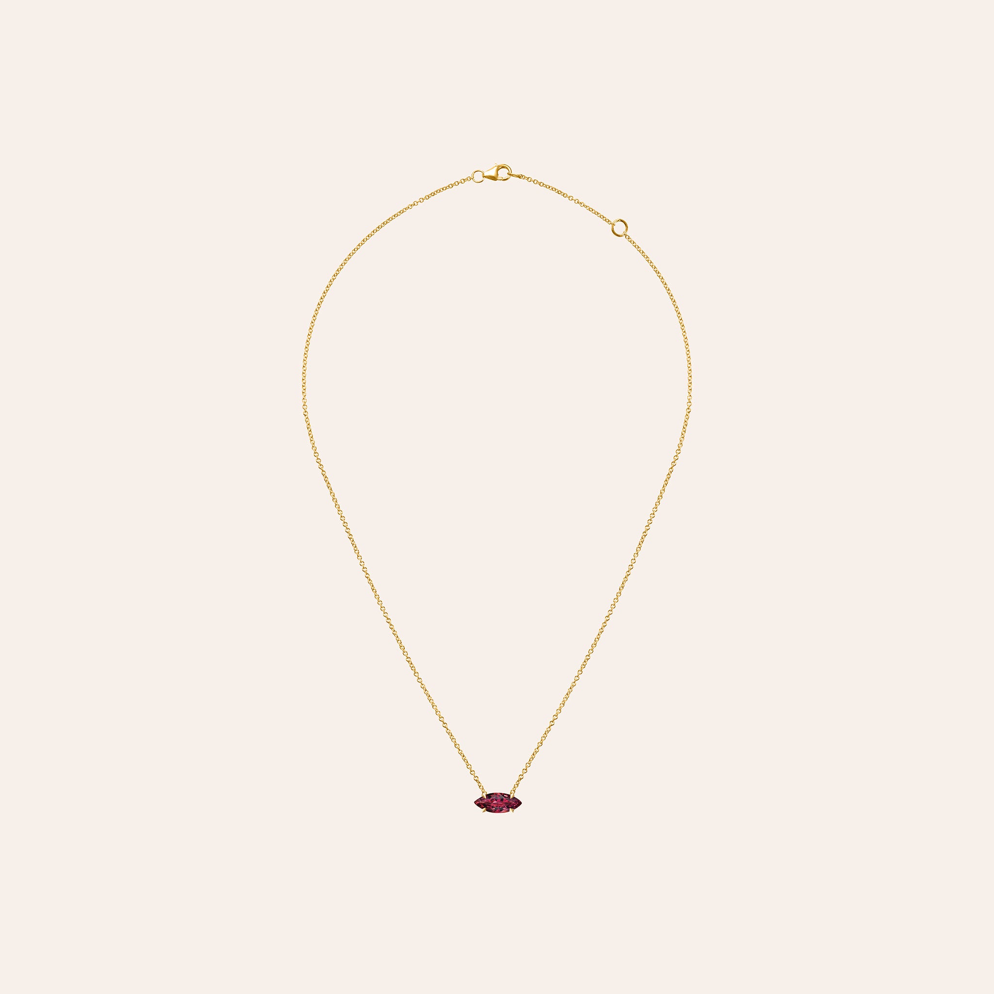 Marquise ruby pendant necklace in 14K rose gold with a four-prong basket setting on a delicate chain.