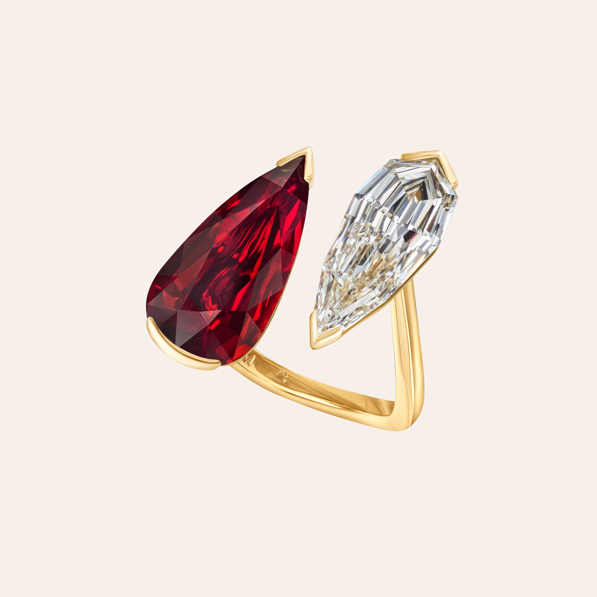 Pear shape ruby and diamond Daphne ring in 18K yellow gold featuring a Mozambique ruby and pear-shaped diamond. At an angle.