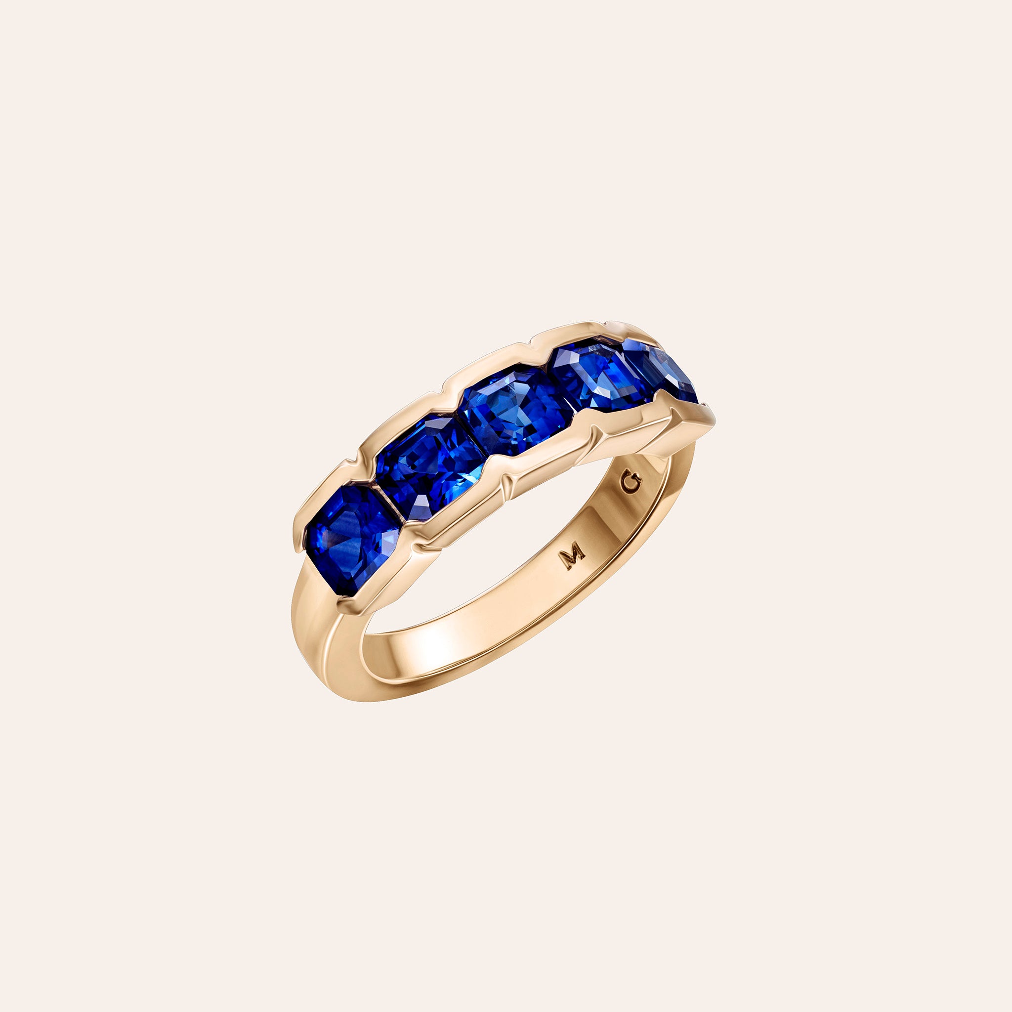 The Blue Sapphire Alexa Pinky Ring by Material Good, featuring five Asscher-cut blue sapphires in a sleek half-bezel setting, handcrafted in 18K rose gold.