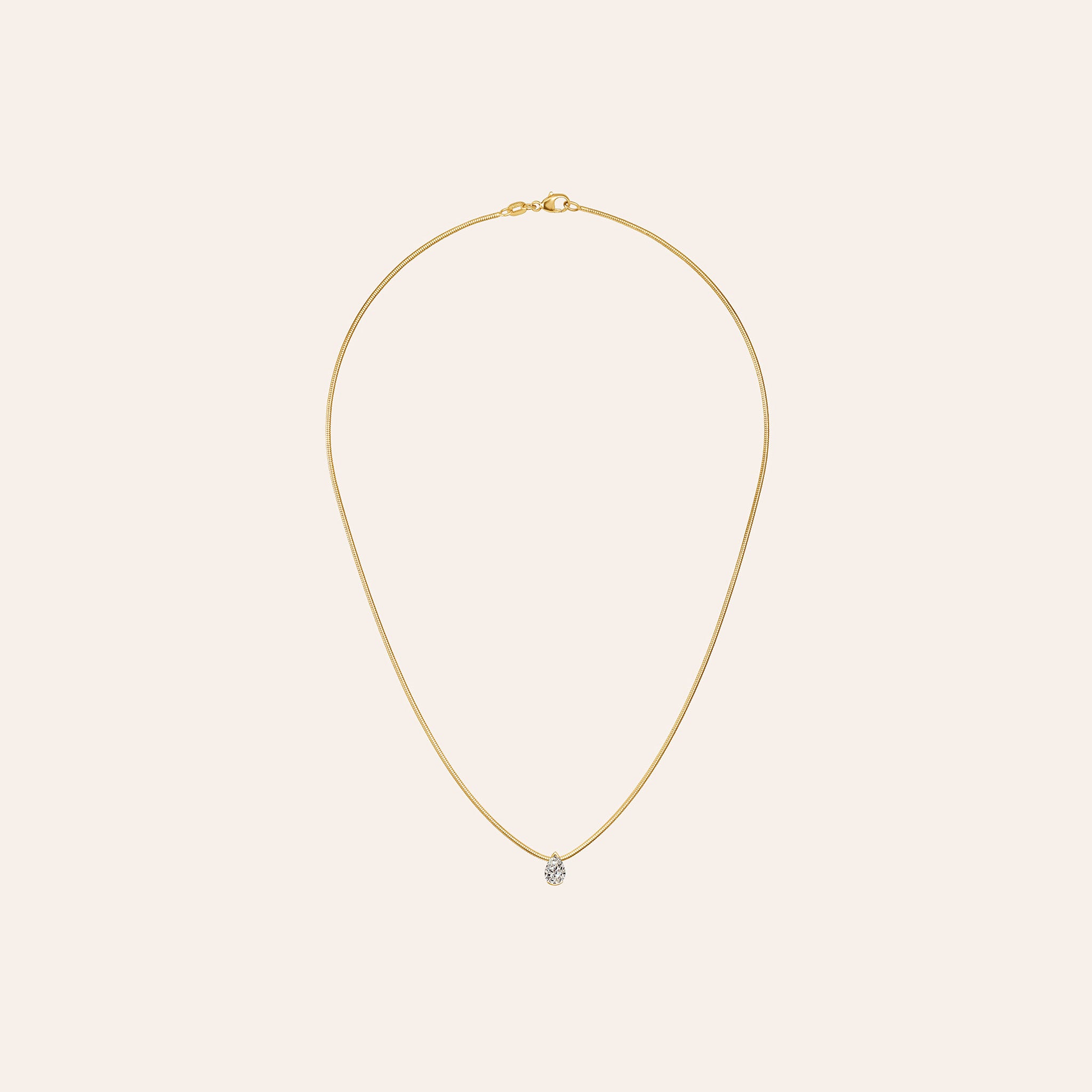 Medium Muse Diamond Pendant with 0.80-carat pear-shaped diamond in 18K yellow gold on a 16-inch snake chain.