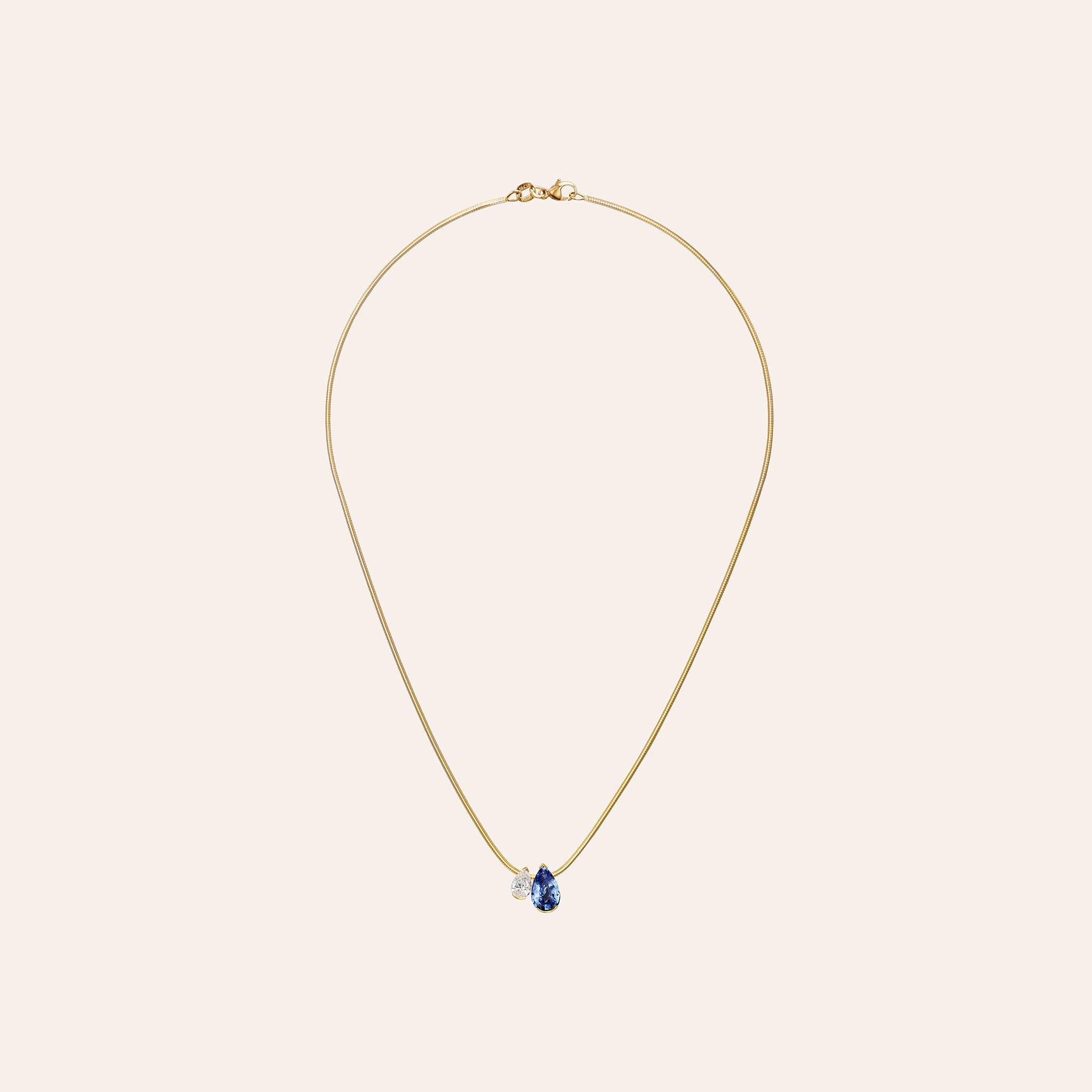 The Blue Sapphire Muse Duo Pendant with a 7.51 ct pear blue sapphire and 1.52 ct pear diamond on an 18k gold snake chain