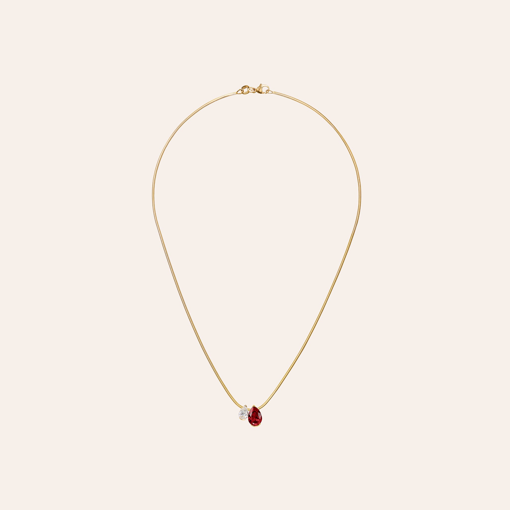 18K yellow gold pendant showcasing approximately 2.00 ct pear-shaped garnet and 0.70 ct pear-shaped diamond suspended on a 16" snake chain.