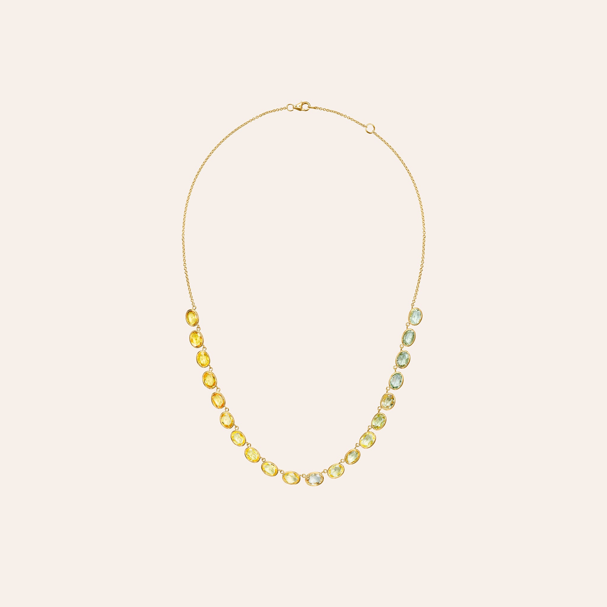 Alternate view of The Lena East-West Ombre Sapphire Necklace in 18K yellow gold, showing oval green and yellow sapphires in an ombré gradient, against a cream background.