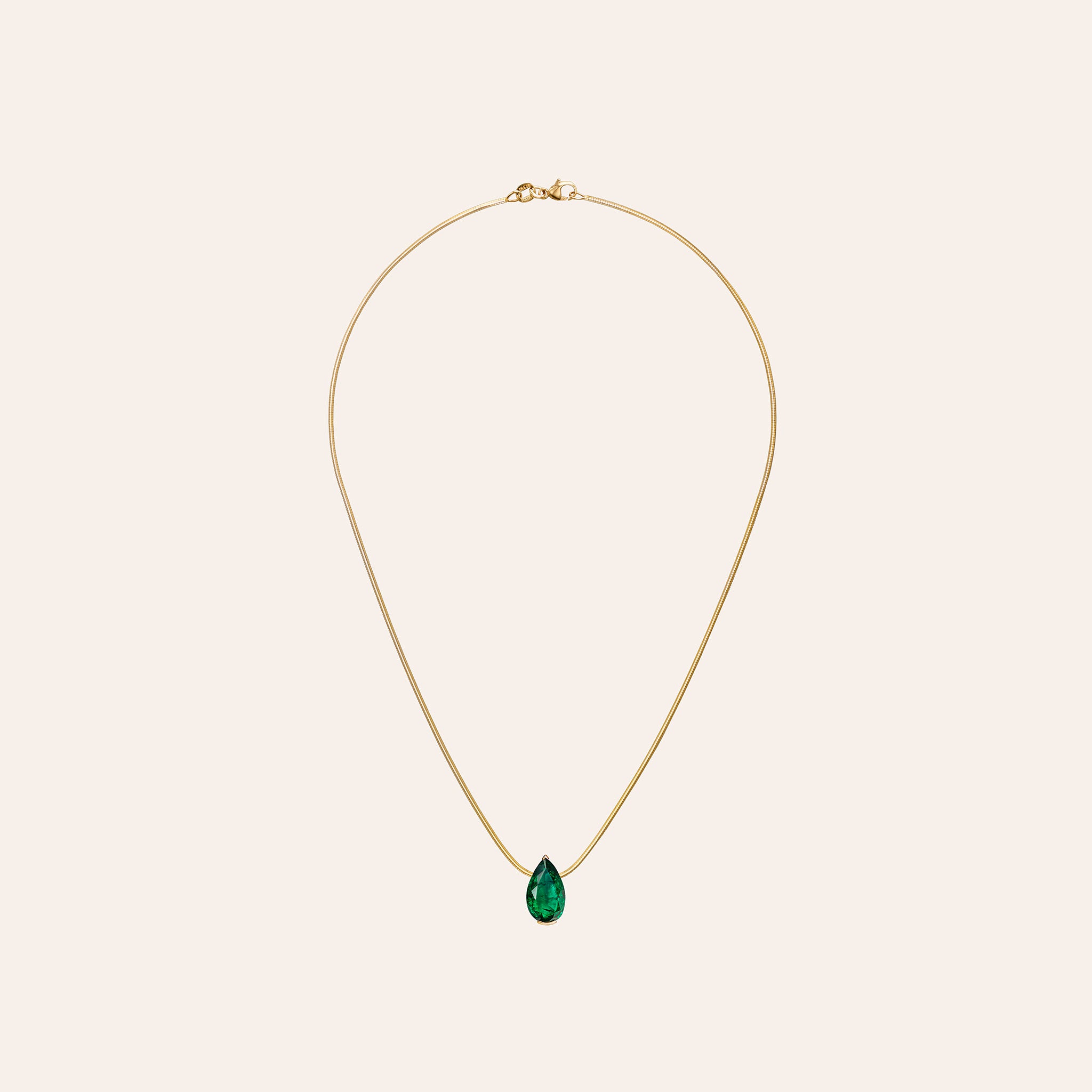 The Muse Emerald Pendant with a 4.20 ct pear-shape emerald on an 18k yellow gold box chain
