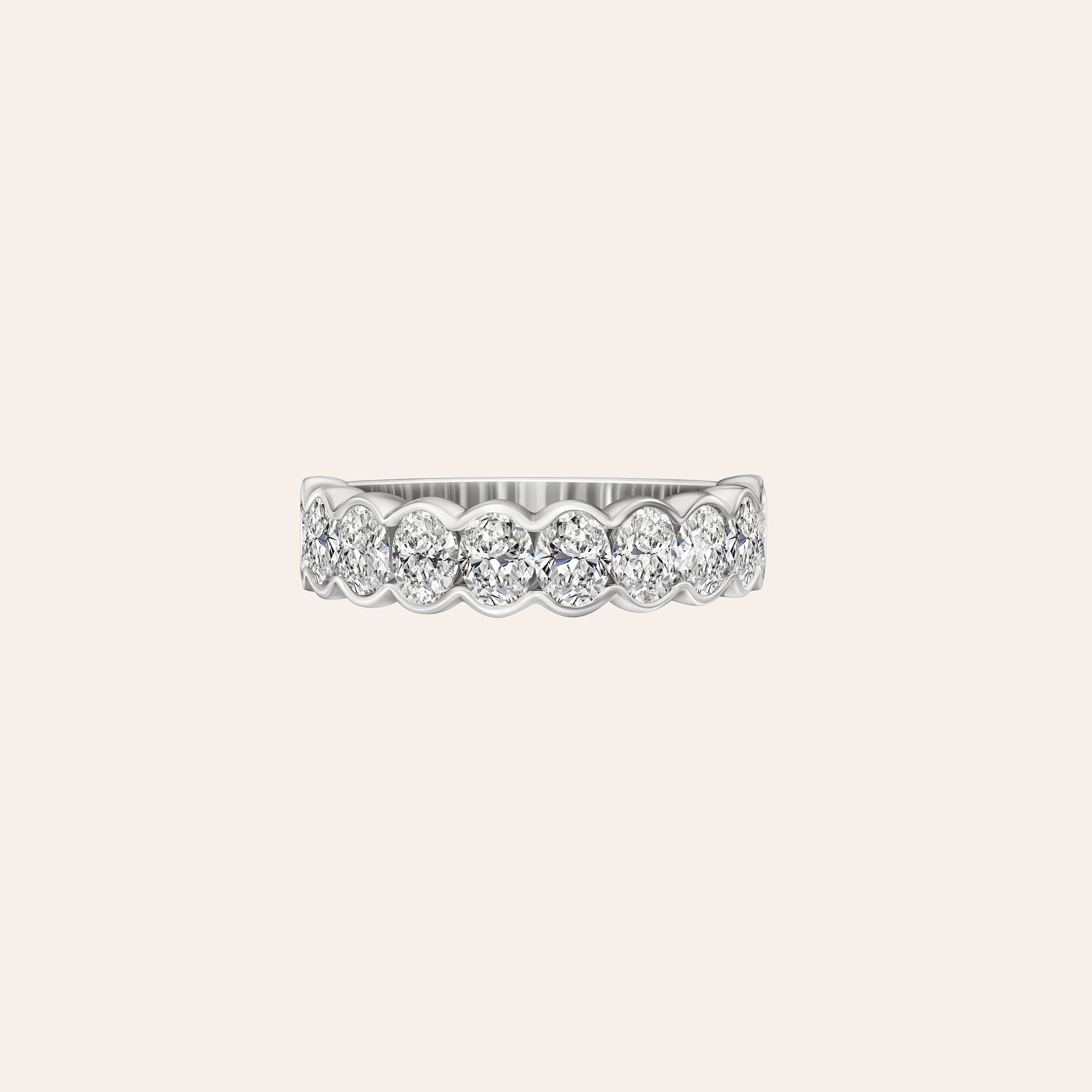 Featuring 2.00 carats of bezel-set oval diamonds, 18K white, yellow and rose gold band